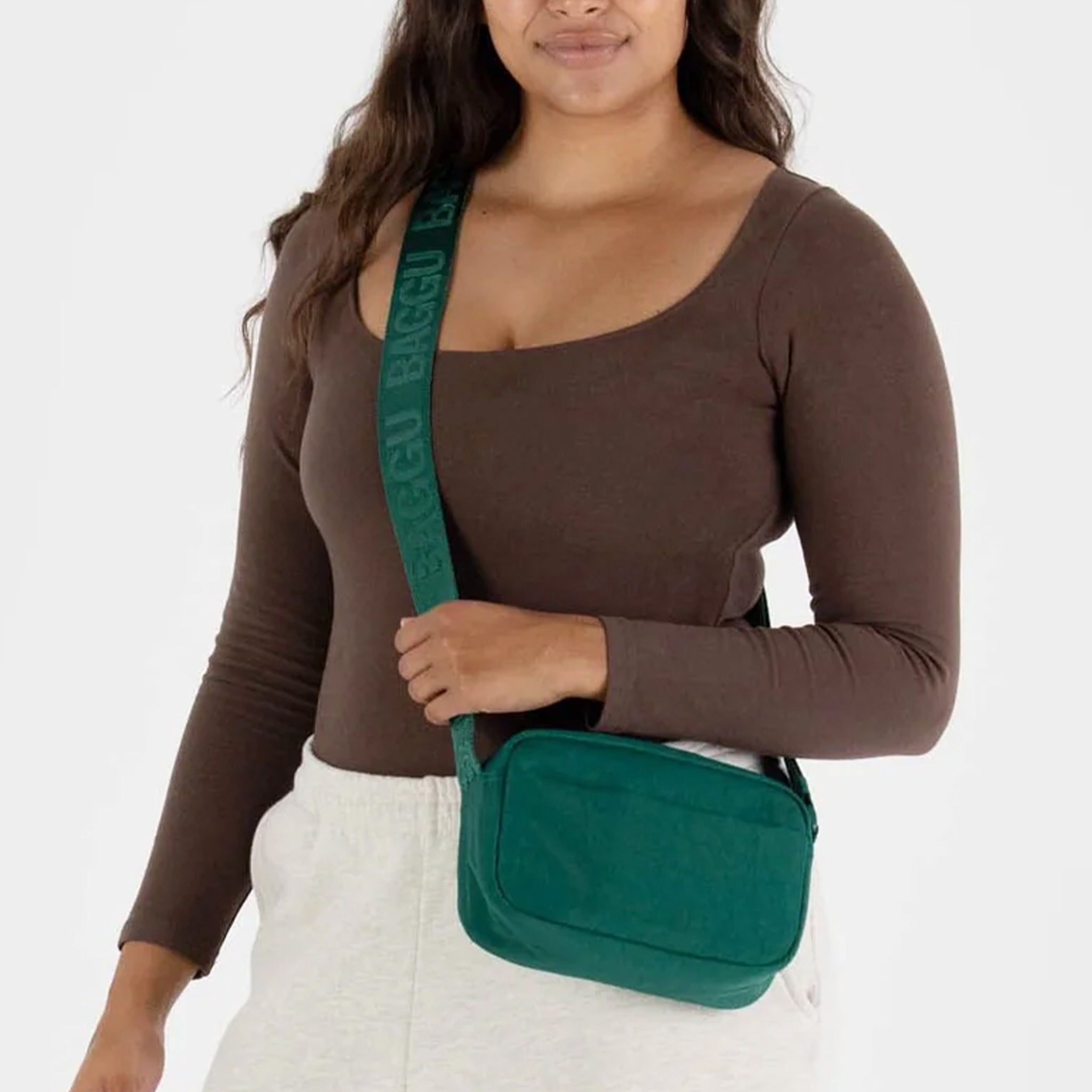 A green crossbody bag made of nylon with an adjustable strap.