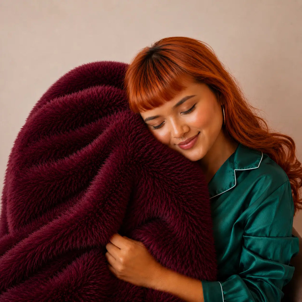 A ruby colored fur blanket with a tag that reads "bestie"