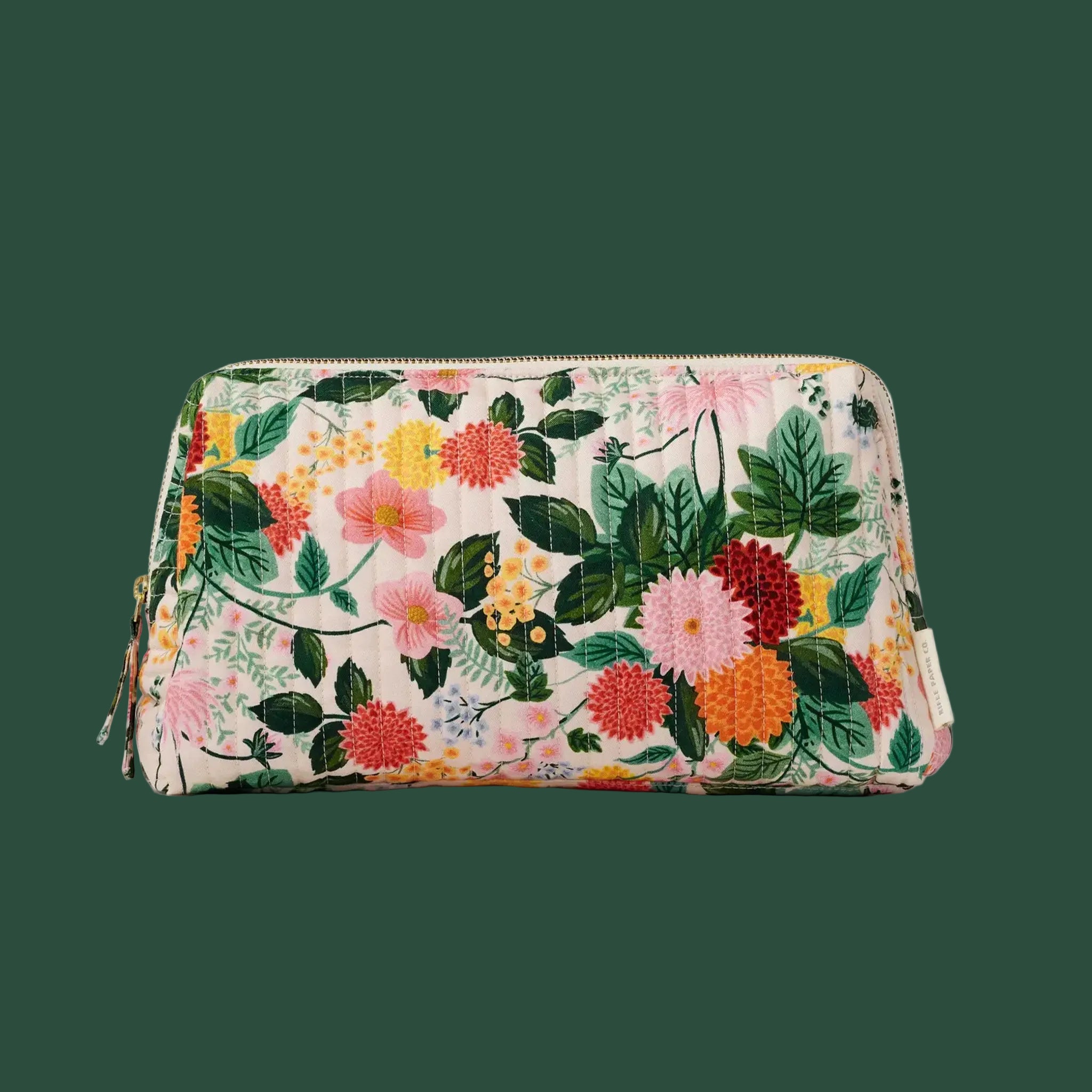 A quilted cosmetic case with a multi colored floral pattern. 