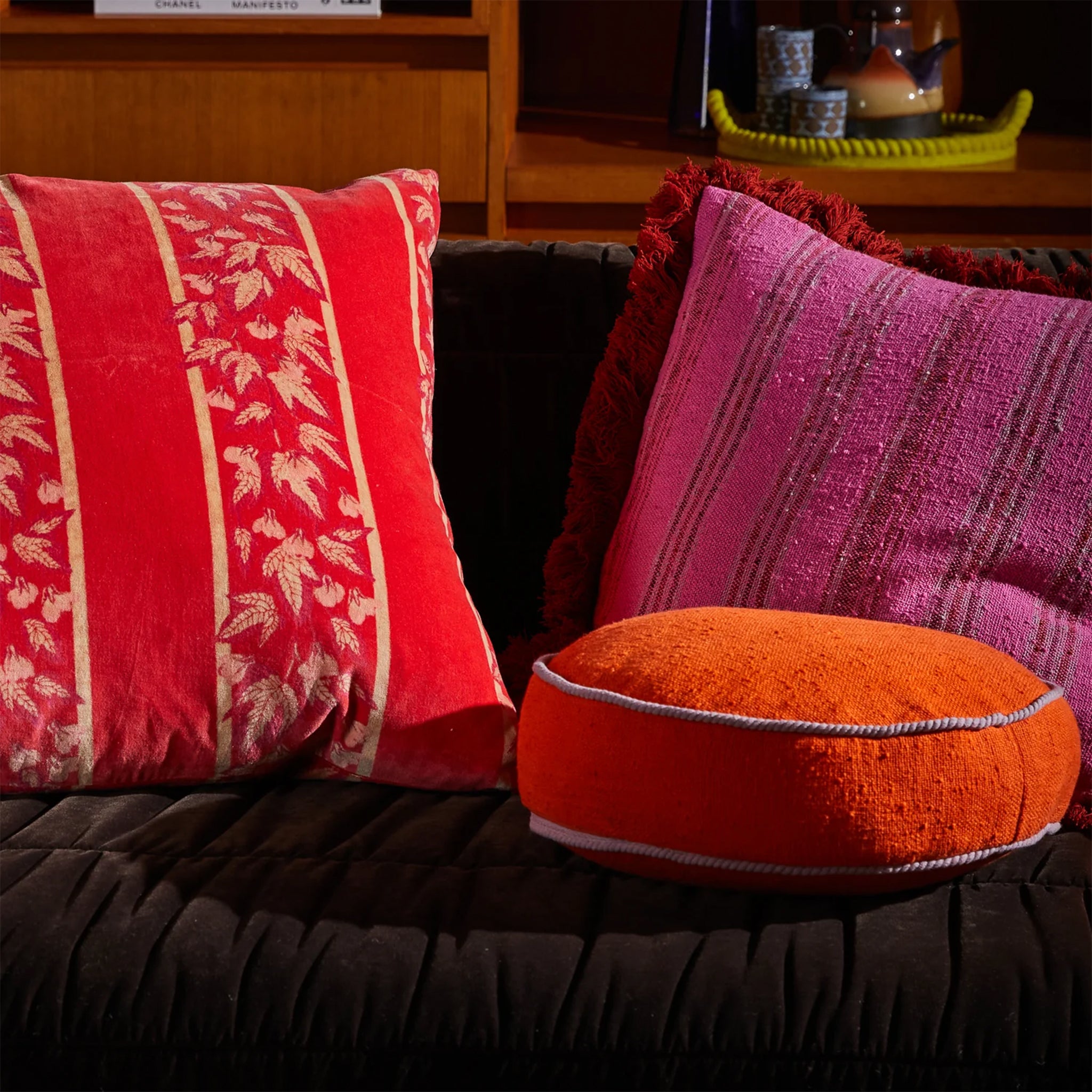 A round orange pillow cushion. 