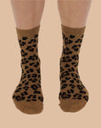 A brown and black pair of leopard print crew socks. 