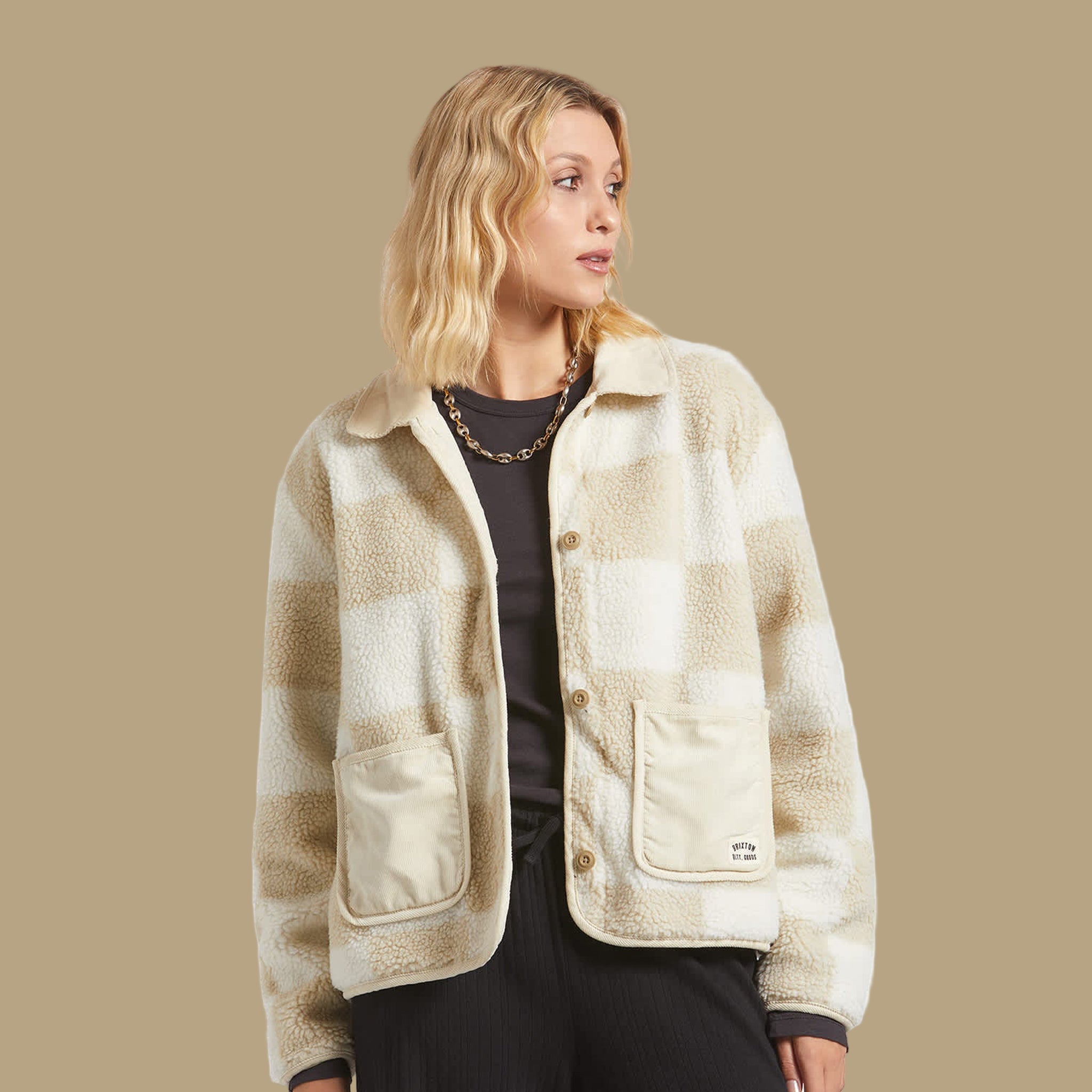 A tan and white checkered sherpa jacket. 