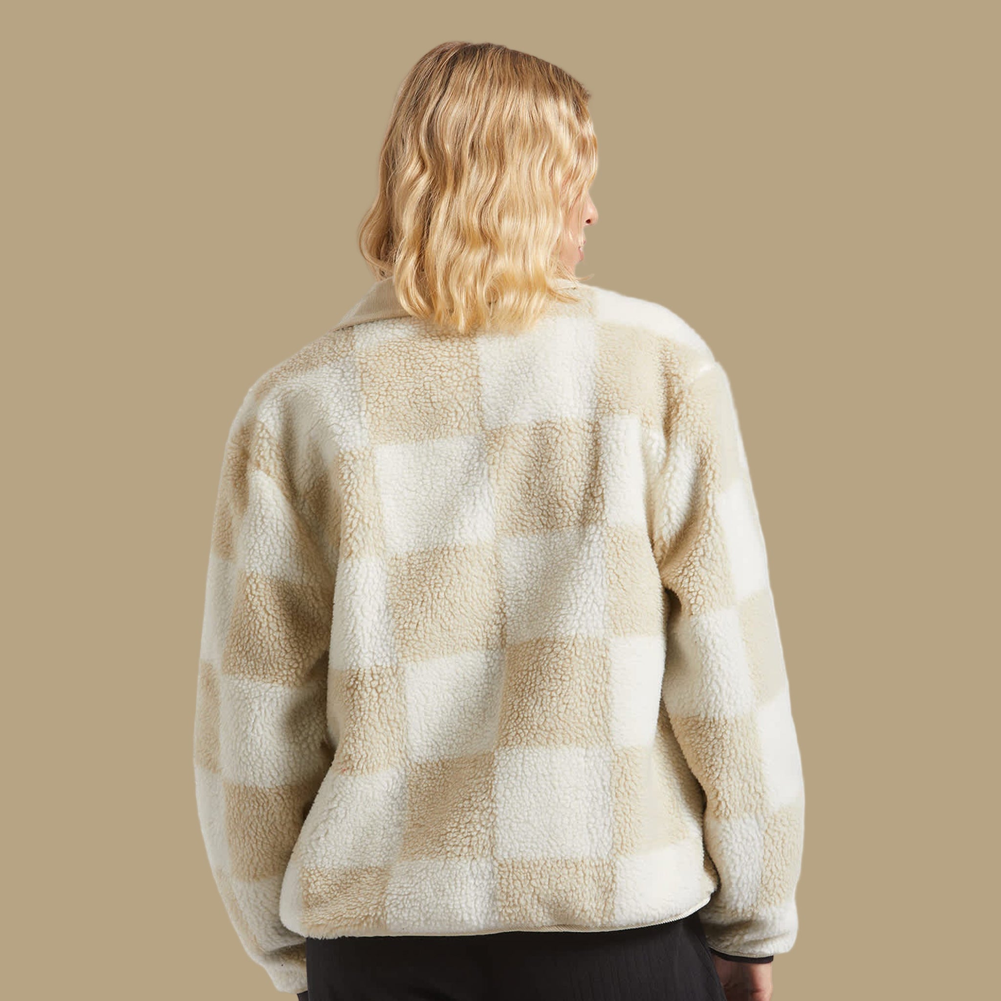 A tan and white checkered sherpa jacket. 