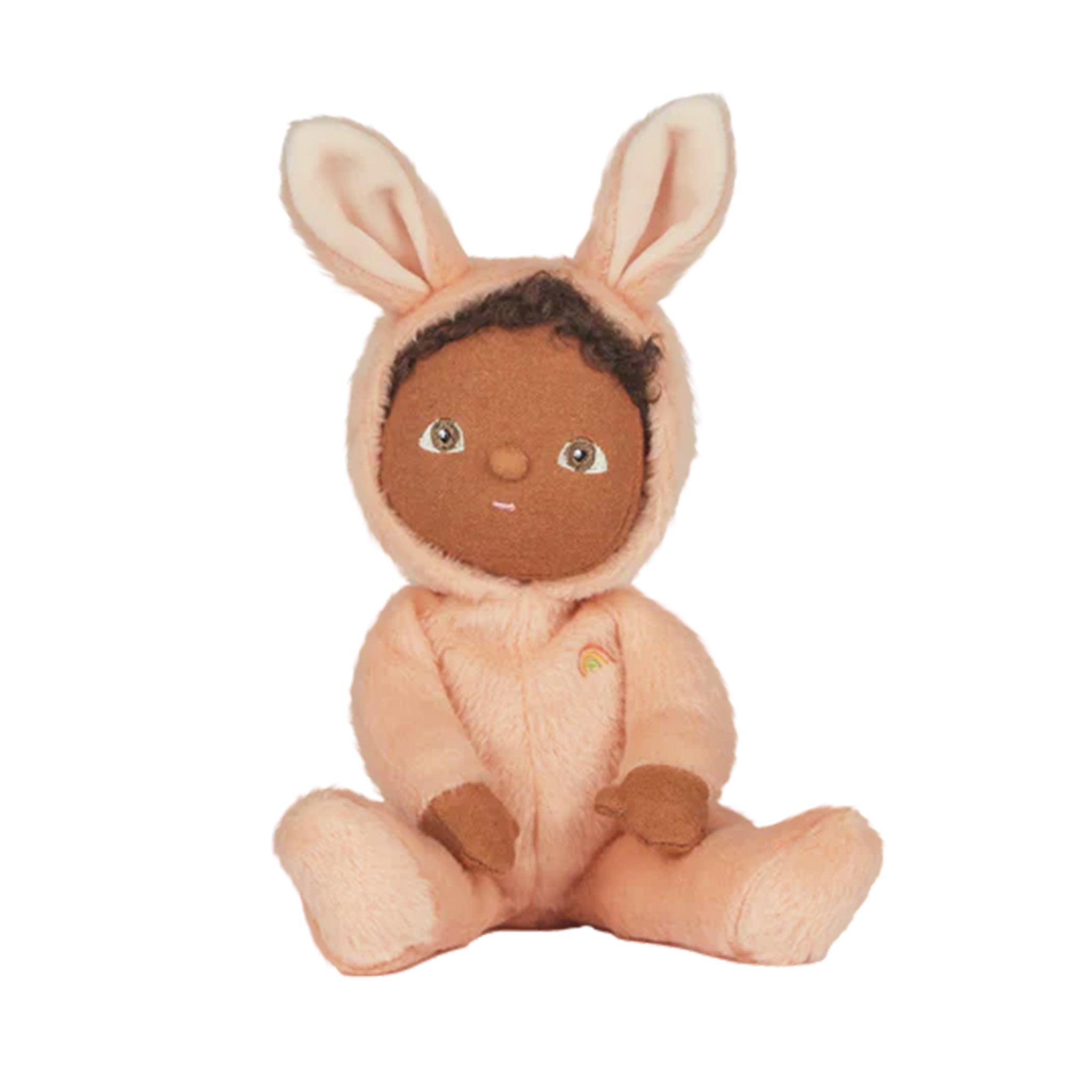 On a white background is a doll with a pink rabbit fuzzy onesie on that has bunny ears. 