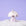 On a purple snowy background is a silver disco mushroom ornament.