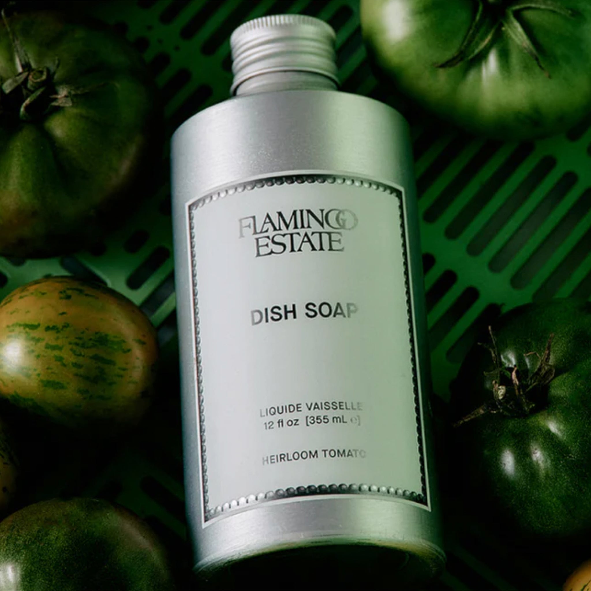 A silver bottle of dish soap with a light blue label that reads, 'Flamingo Estate Dish Soap'. 