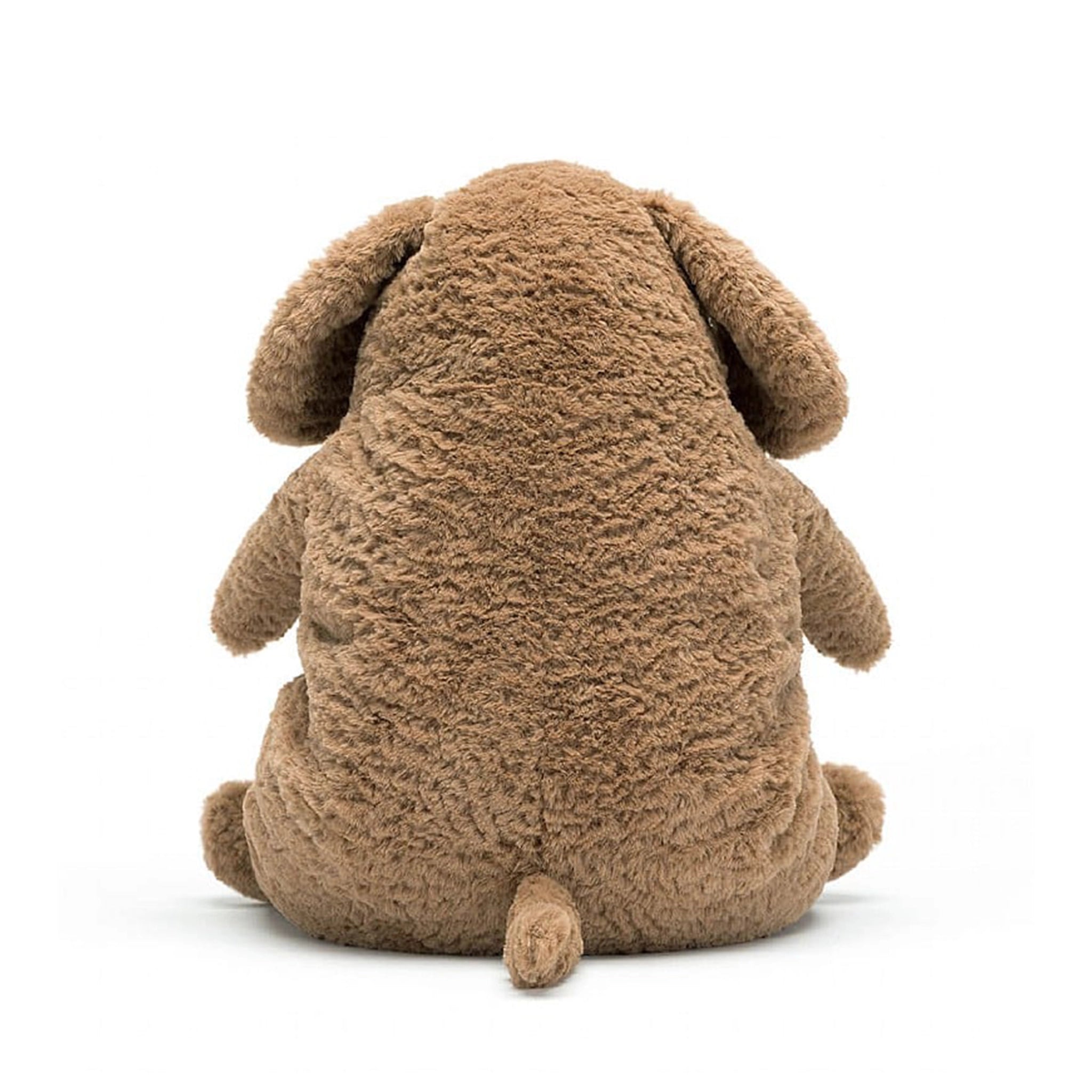 On a white background is a snuggly brown stuffed animal dog with sleepy eyes and a chunky figure.