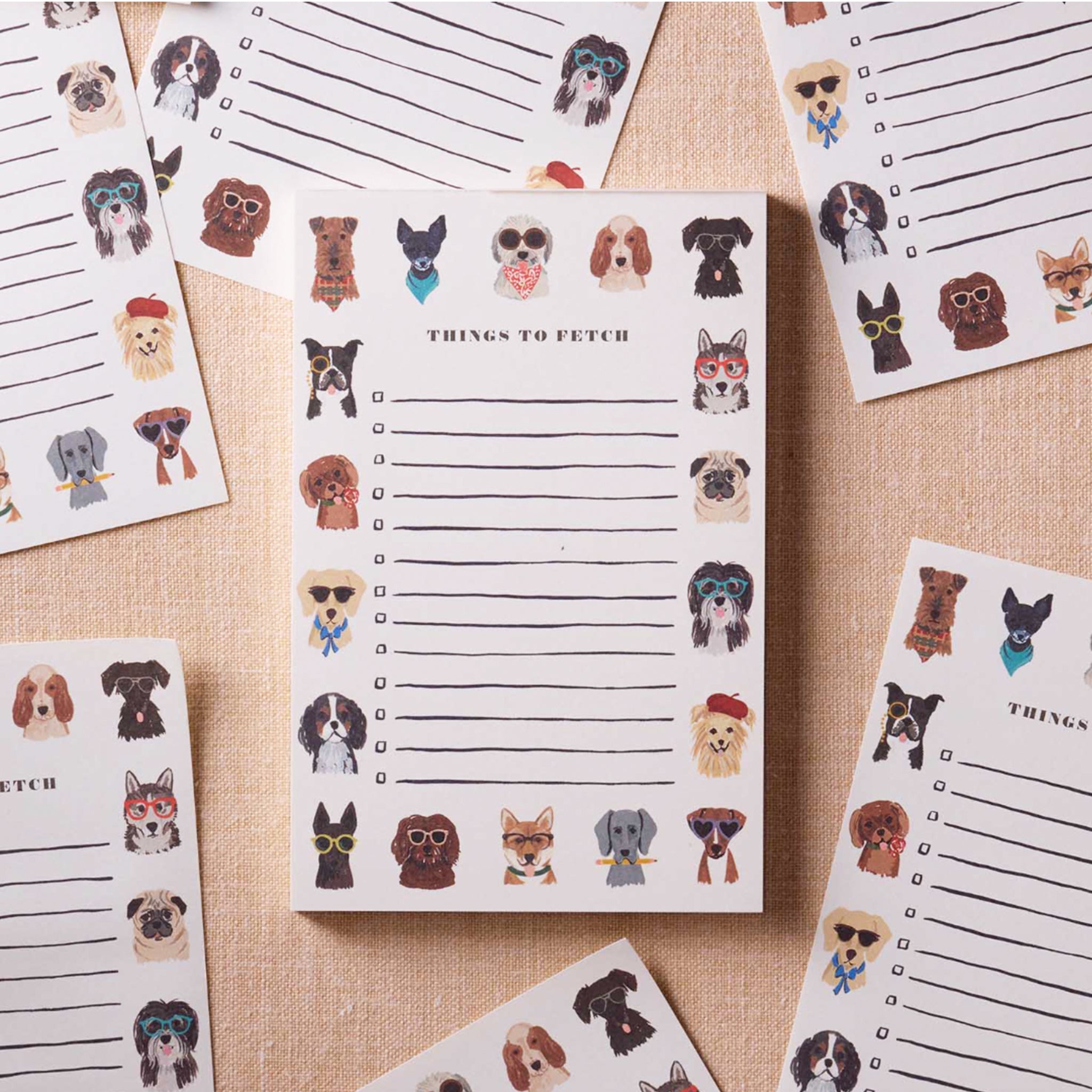 A notepad with a border of illustrations of different dog breeds and text in the center that reads, 'Things To Fetch' and lines and check boxes. 