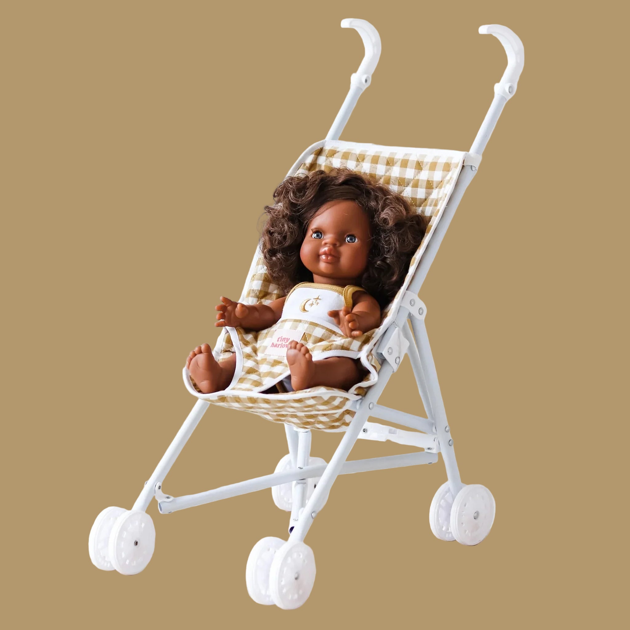 A mustard gingham print toy doll stoller. 