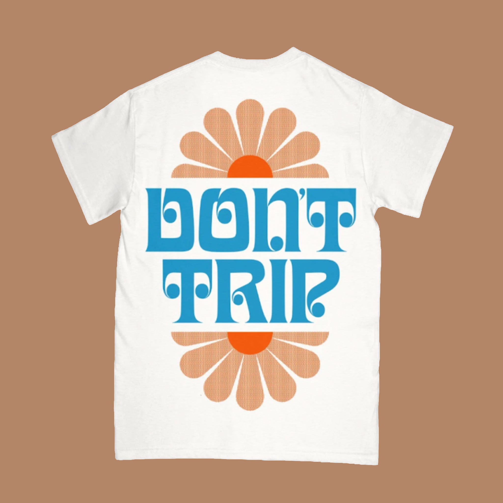 White short-sleeve T-shirt shown from the back with bold blue “Don’t Trip” text over a retro orange and tan sunburst graphic.