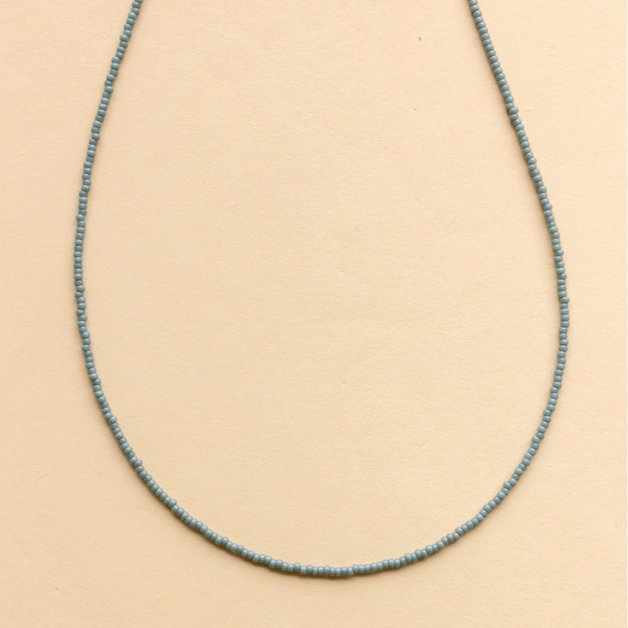 A light blue beaded necklace. 