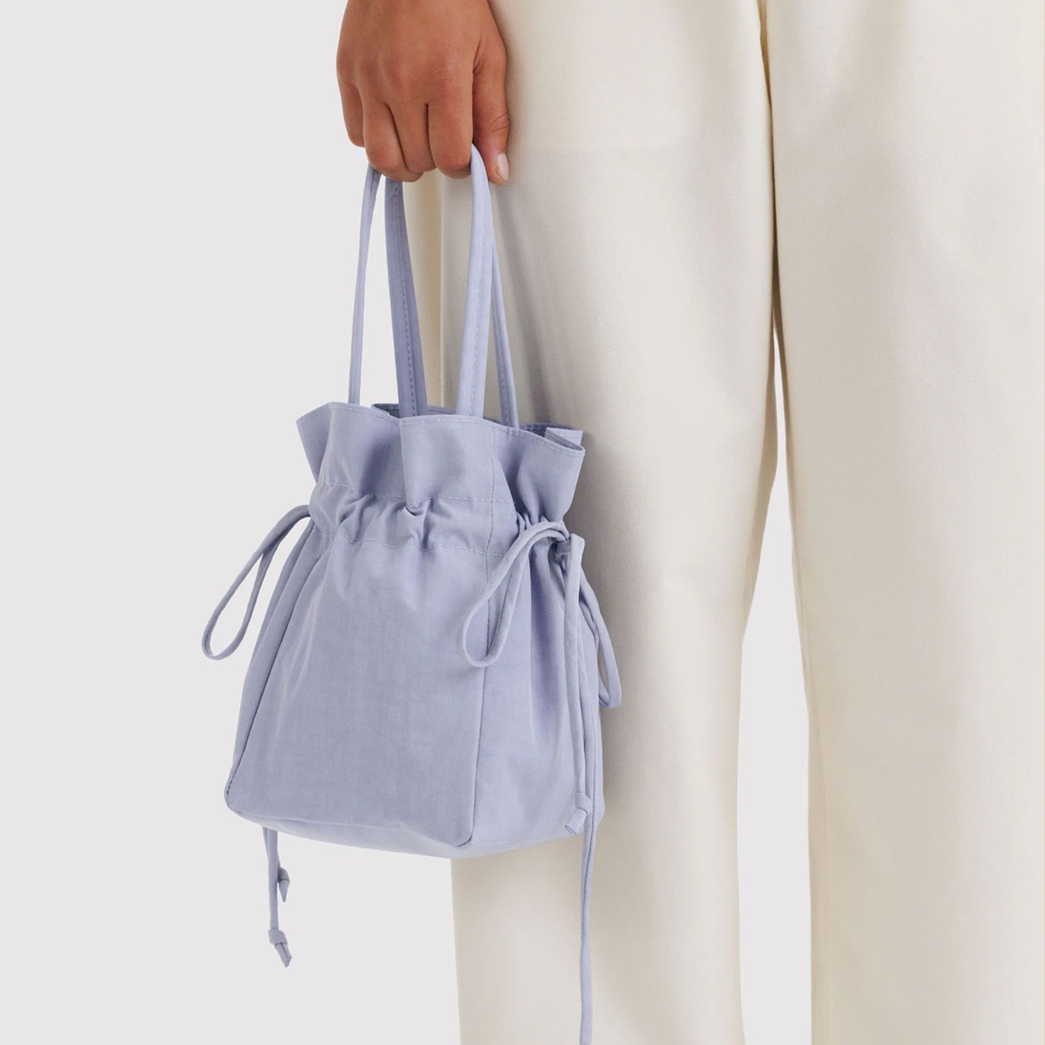 A light blueish / purple drawstring bag. 
