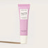 A pink tube of lip balm that reads, "Herbivore Dream Jelly Strawberry Lip Balm". 