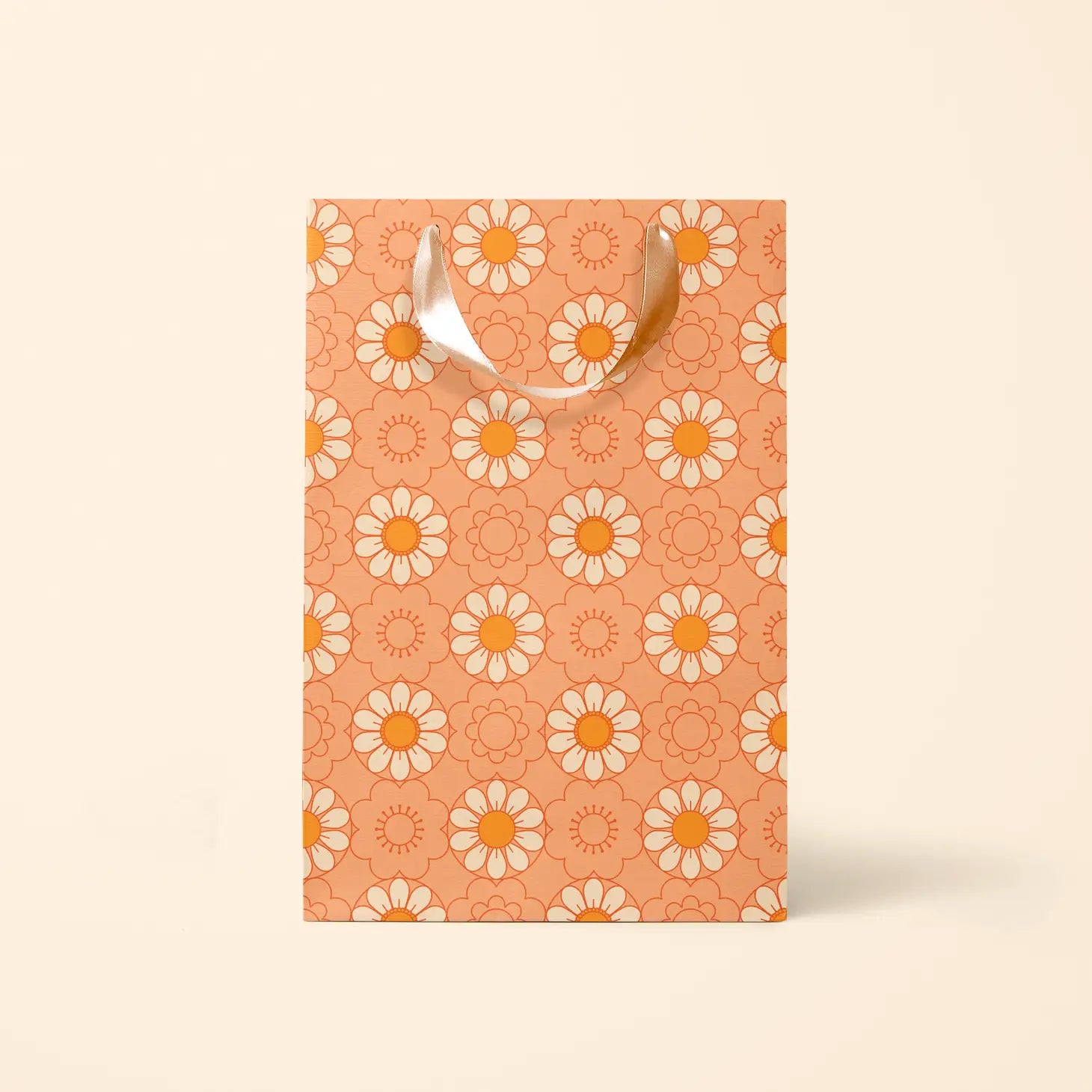 On an ivory background is the medium gift bag with an orange color and an ivory and orange daisy pattern. 