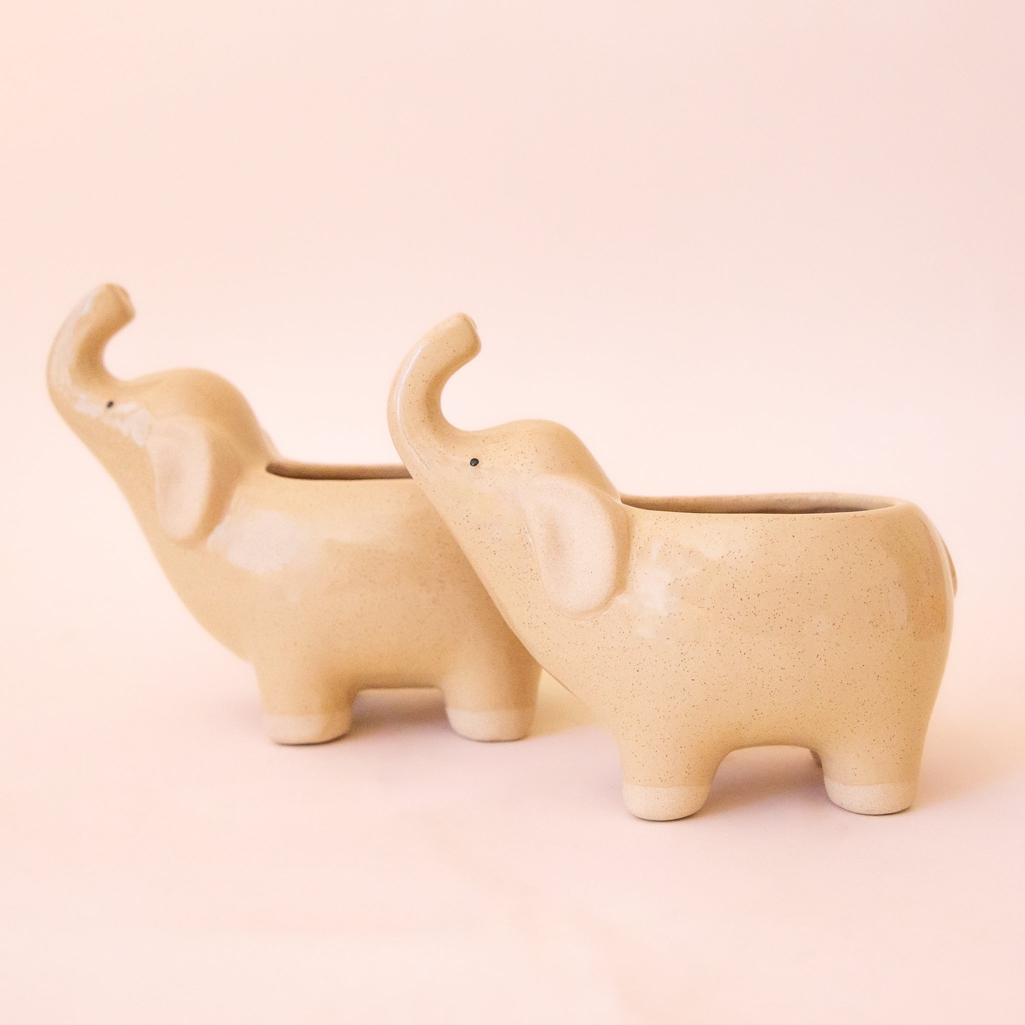 A cream speckled ceramic elephant planter. 