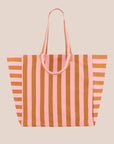 A pink and orange vertical striped canvas tote bag. 