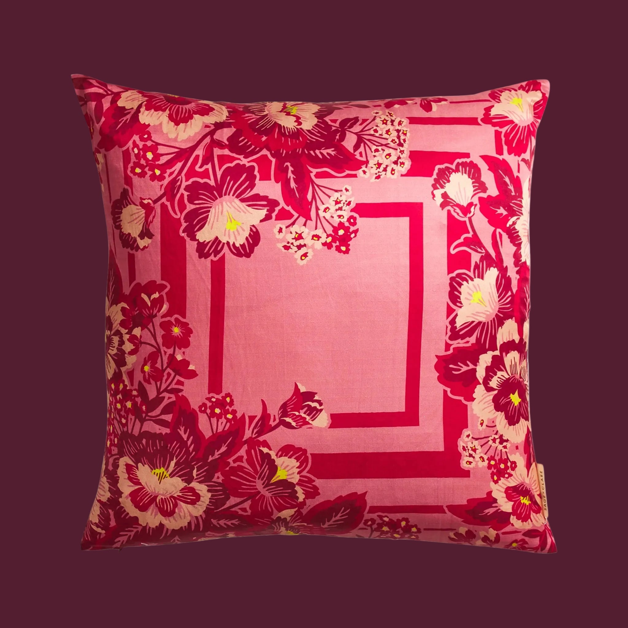 A pink floral print pillow. 