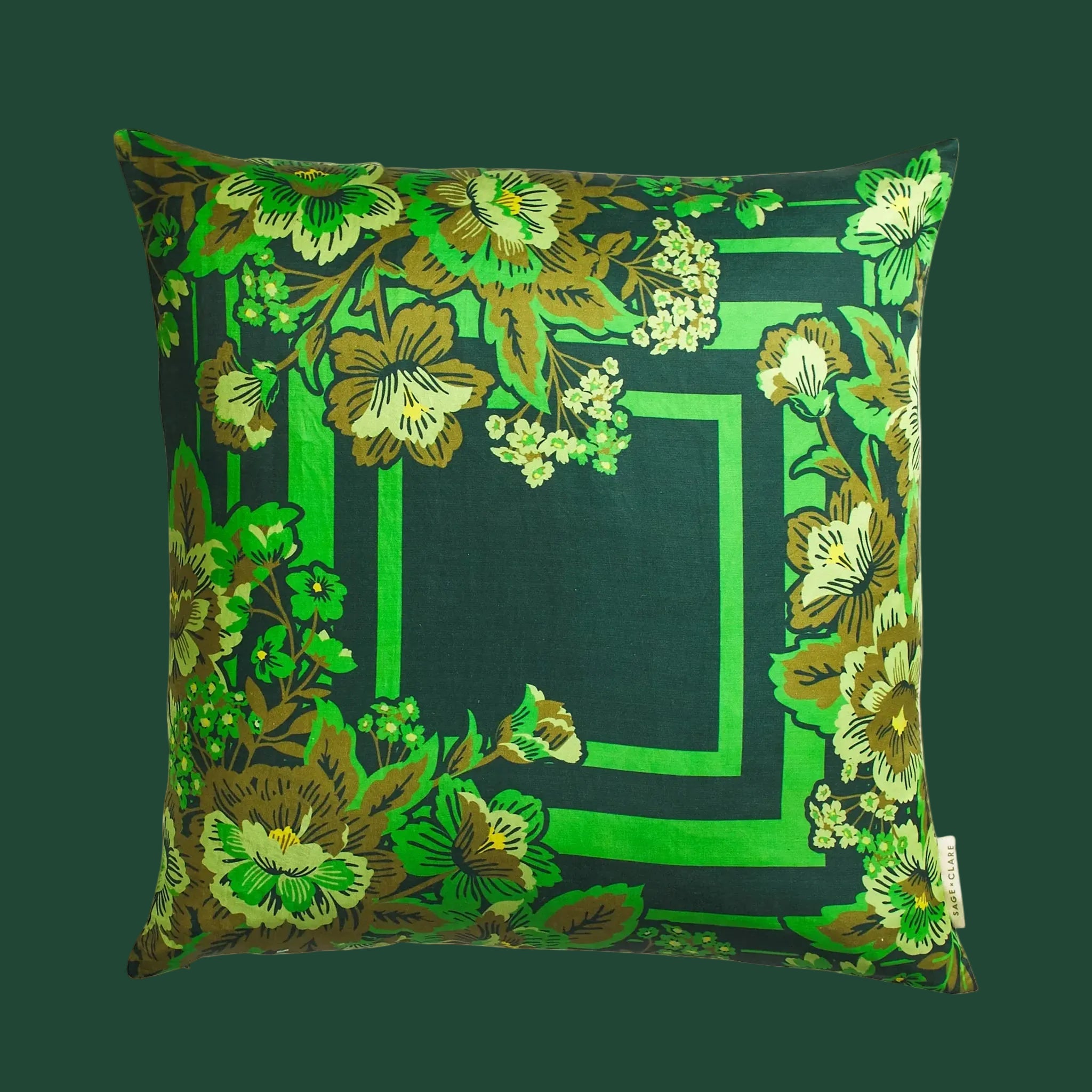 A green square cushion pillow with a floral print. 