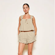 A light olive green flowy tank top with frilly shoulder straps. 