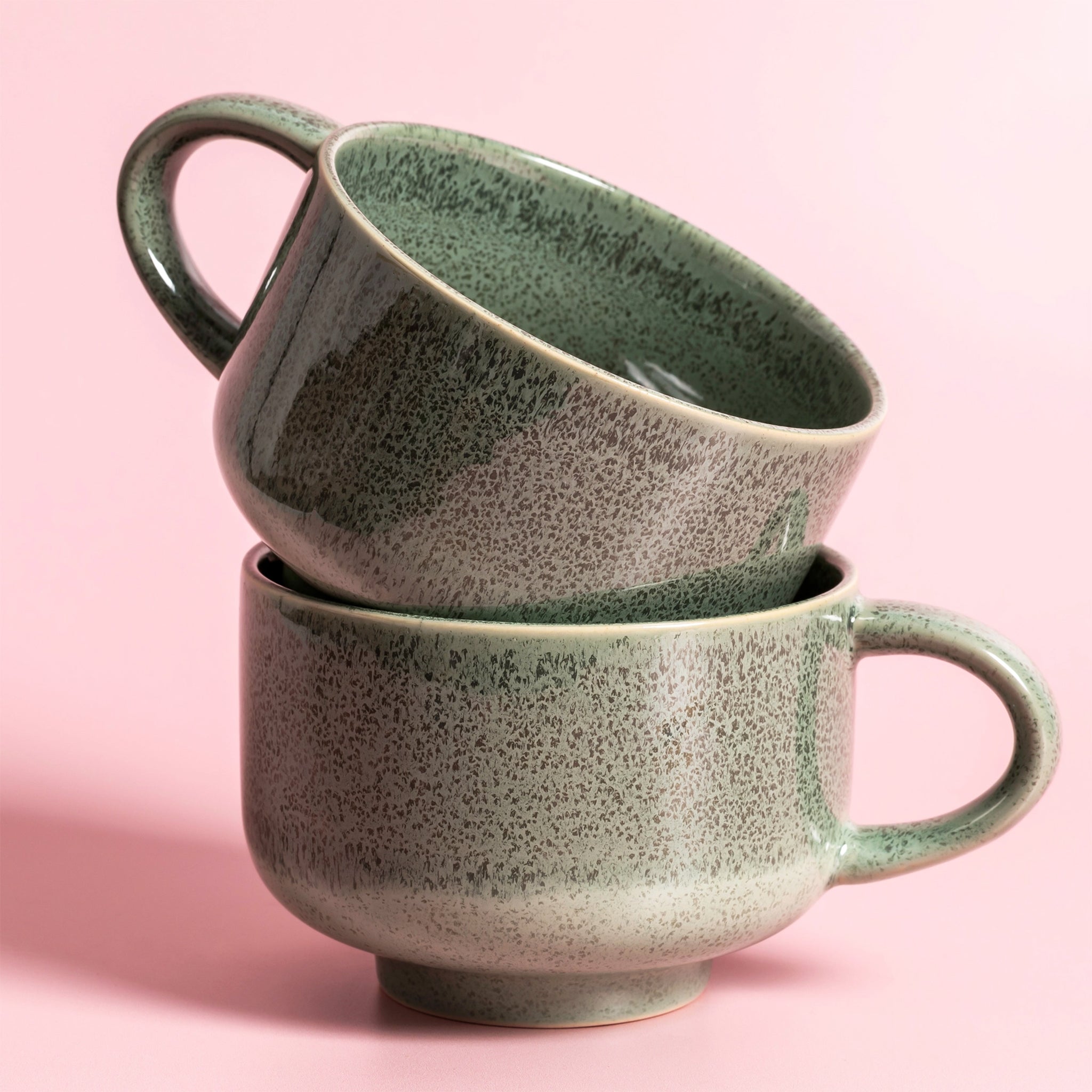 A green speckled ceramic mug. 