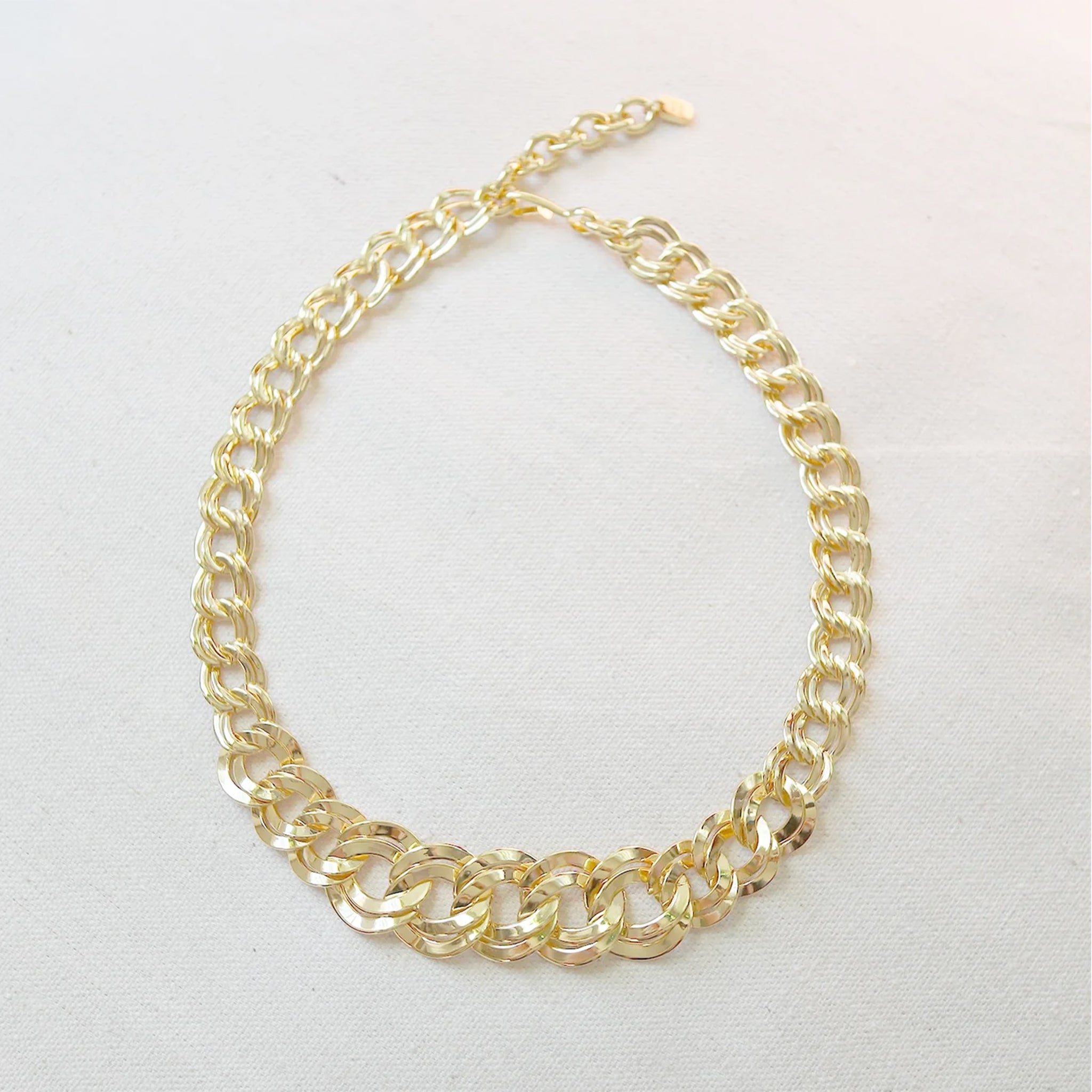 A gold chunky chain necklace. 