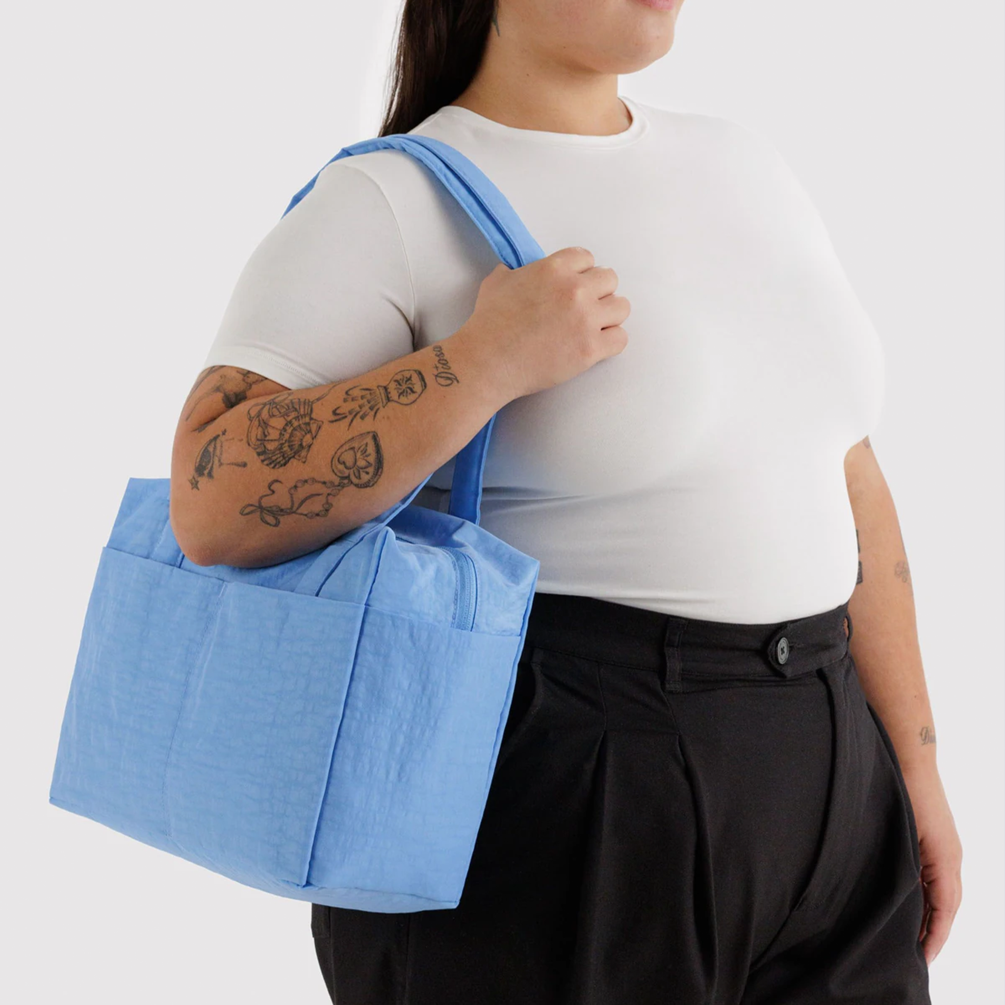 A powder blue shoulder bag on a model.
