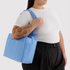 A powder blue shoulder bag on a model.