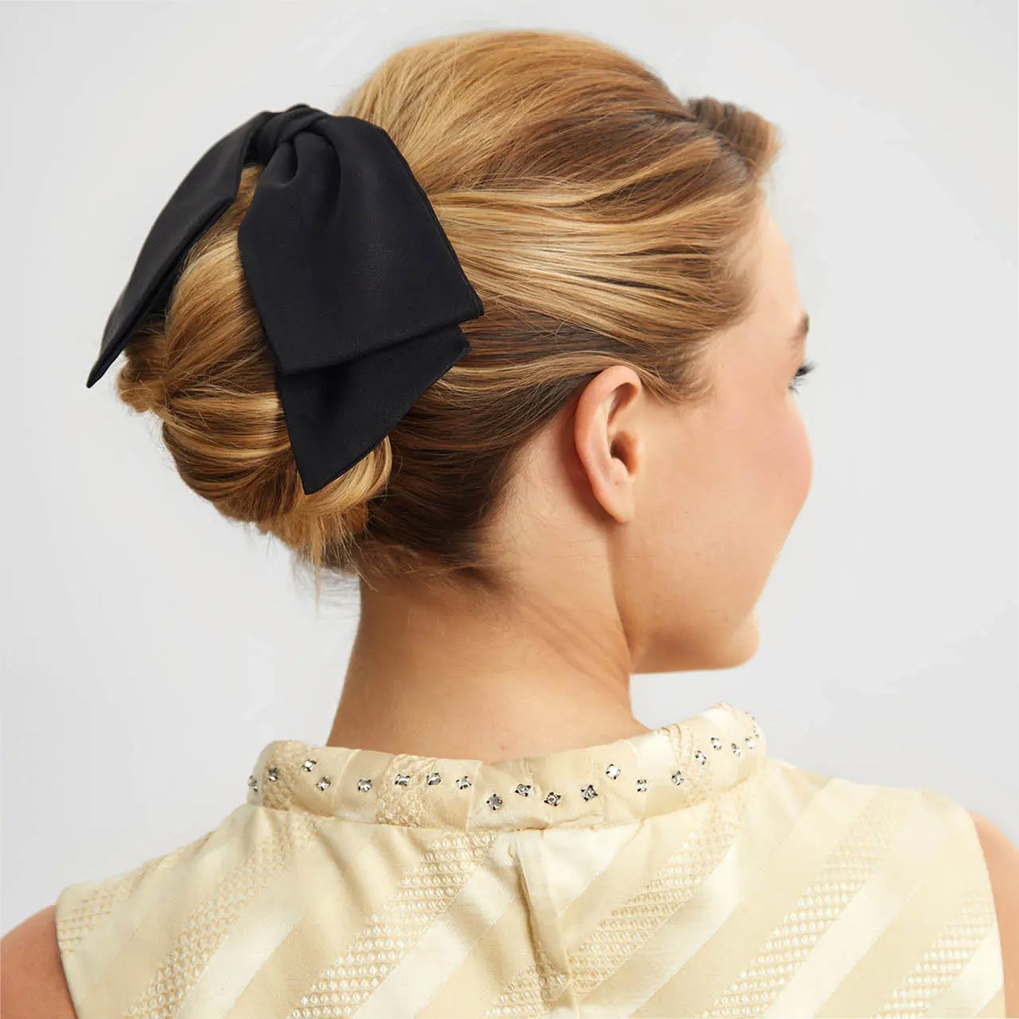 A black fabric bow hair clip. 