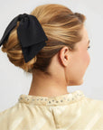  A black fabric bow hair clip. 