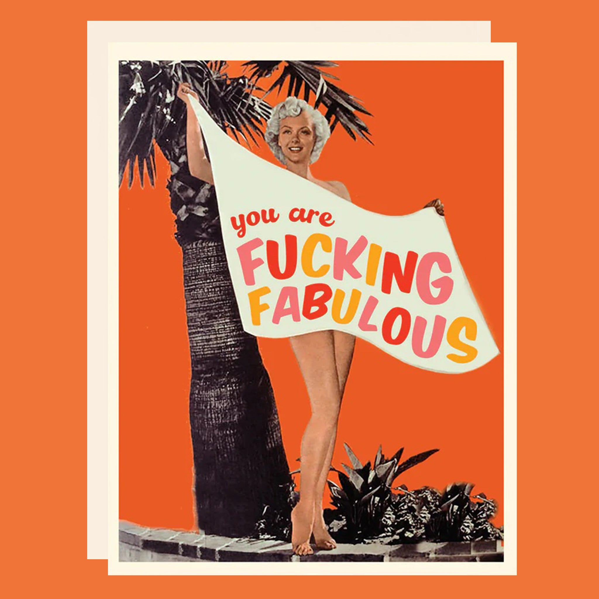Greeting card with a woman on the beach holding a sign. The sign reads "You are fucking fabulous". 