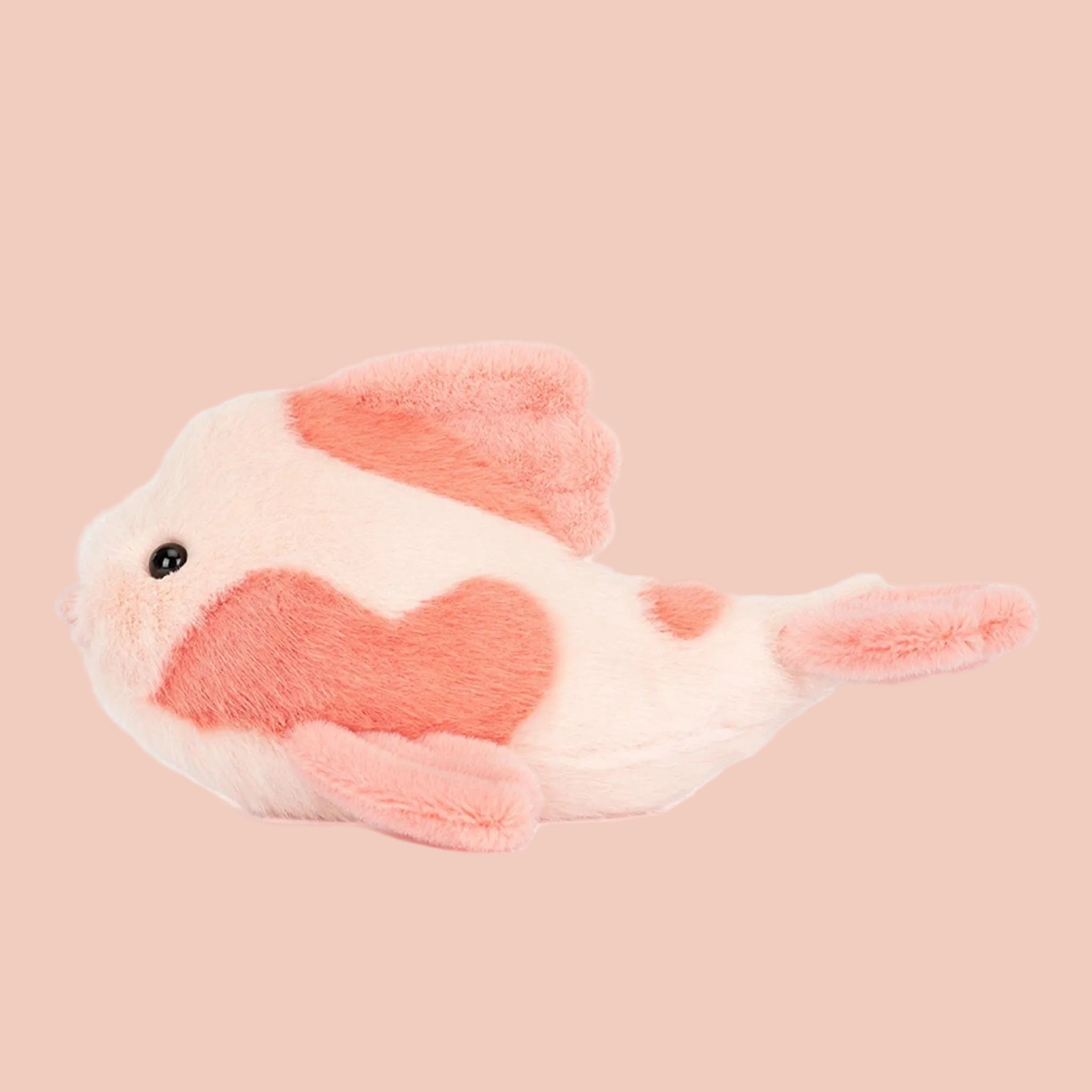 Plush toy fish with pink and white color on a white background