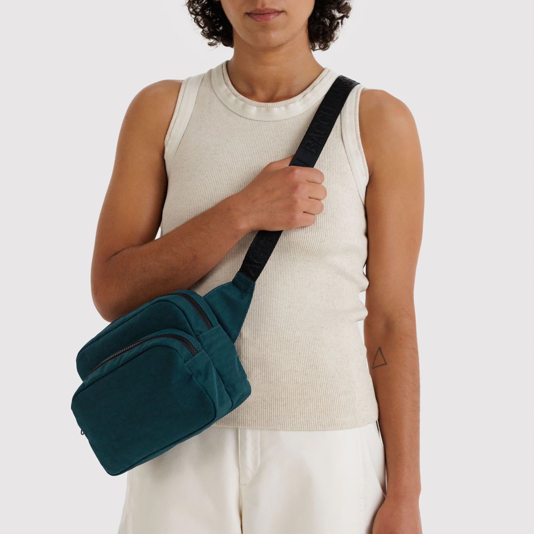 A dark teal and black nylon fanny pack. 