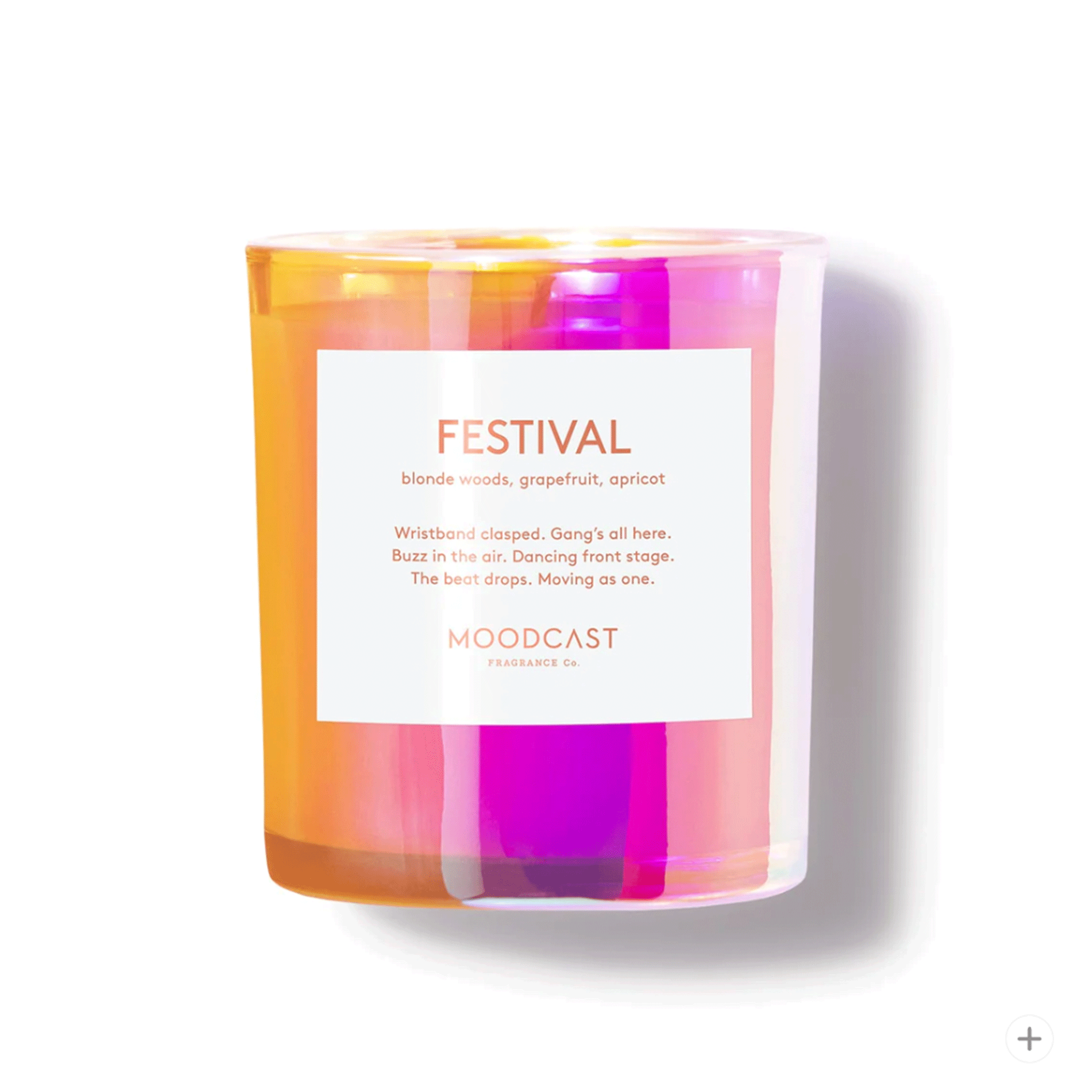 On a white background is a glass multicolored candle with a white label that reads, "Festival" and the scent notes. 
