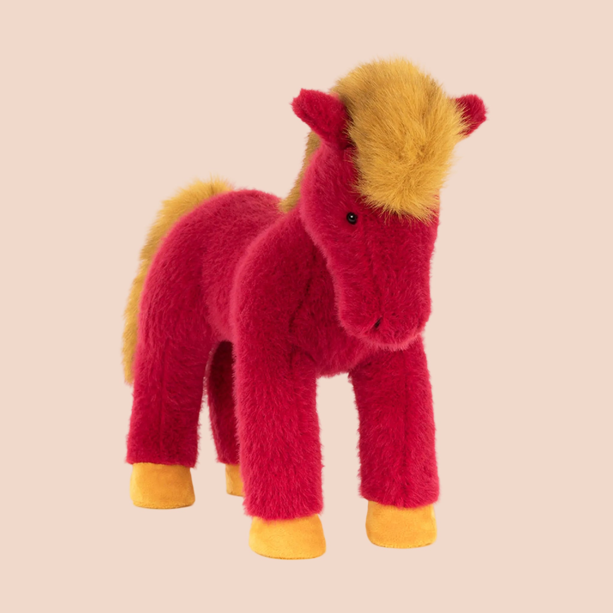 A red and mustard yellow horse shaped stuffed animal. 