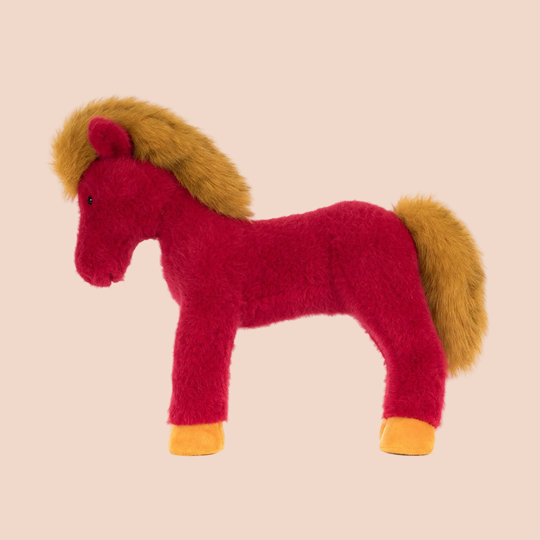 A red and mustard yellow horse shaped stuffed animal. 