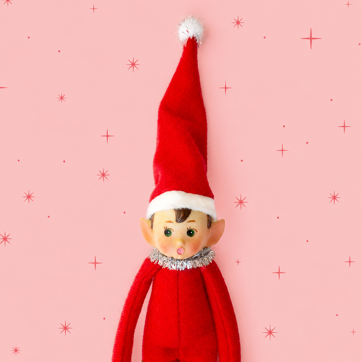 A red elf shaped ornament. 