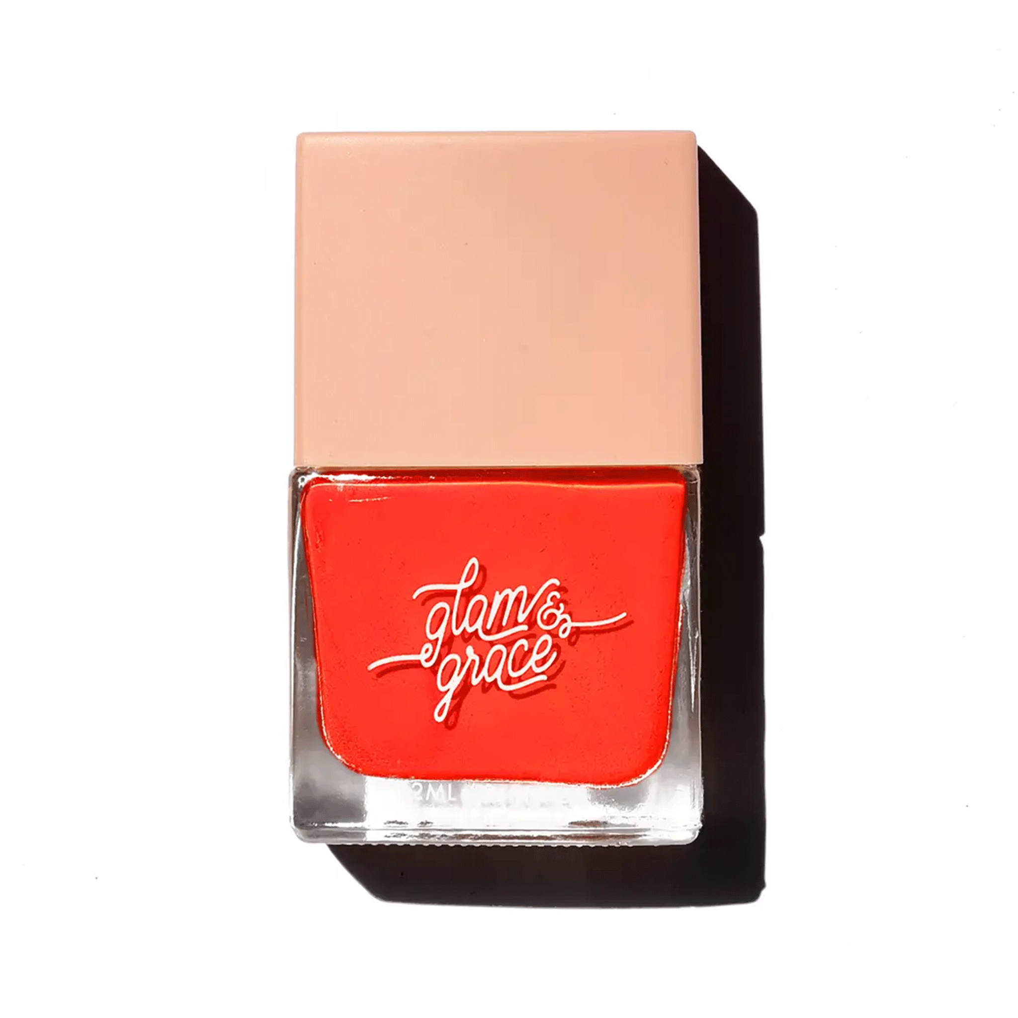 On a white background is a red nail polish in a square bottle. 