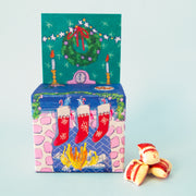 A fireplace shaped box of candies. 