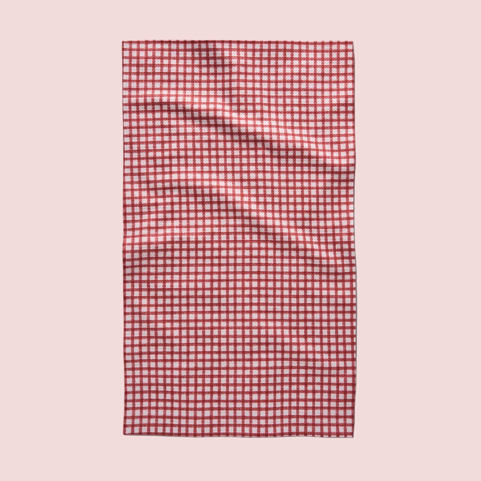 A red and ivory plaid print one sided kitchen towel. 