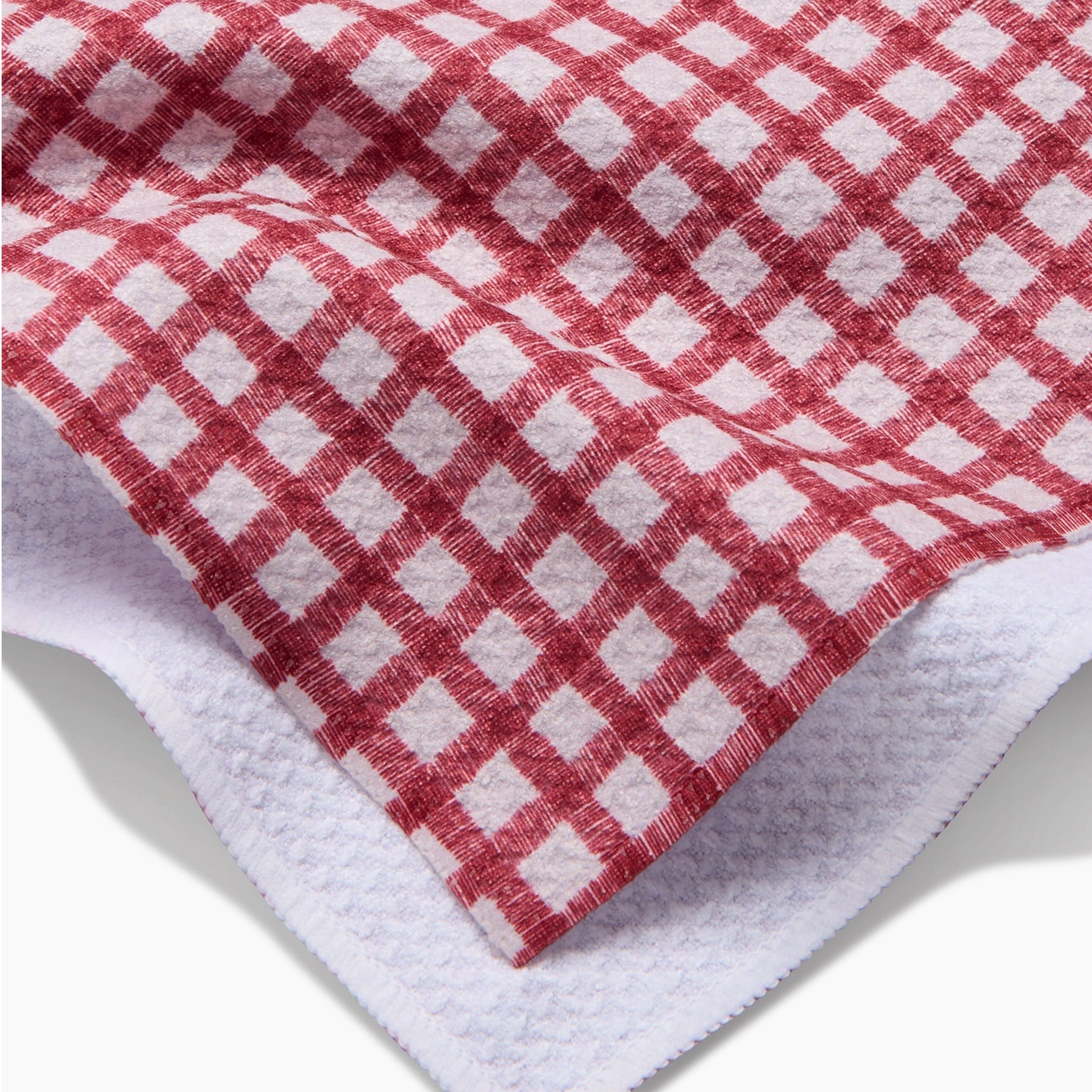 A red and ivory plaid print one sided kitchen towel. 