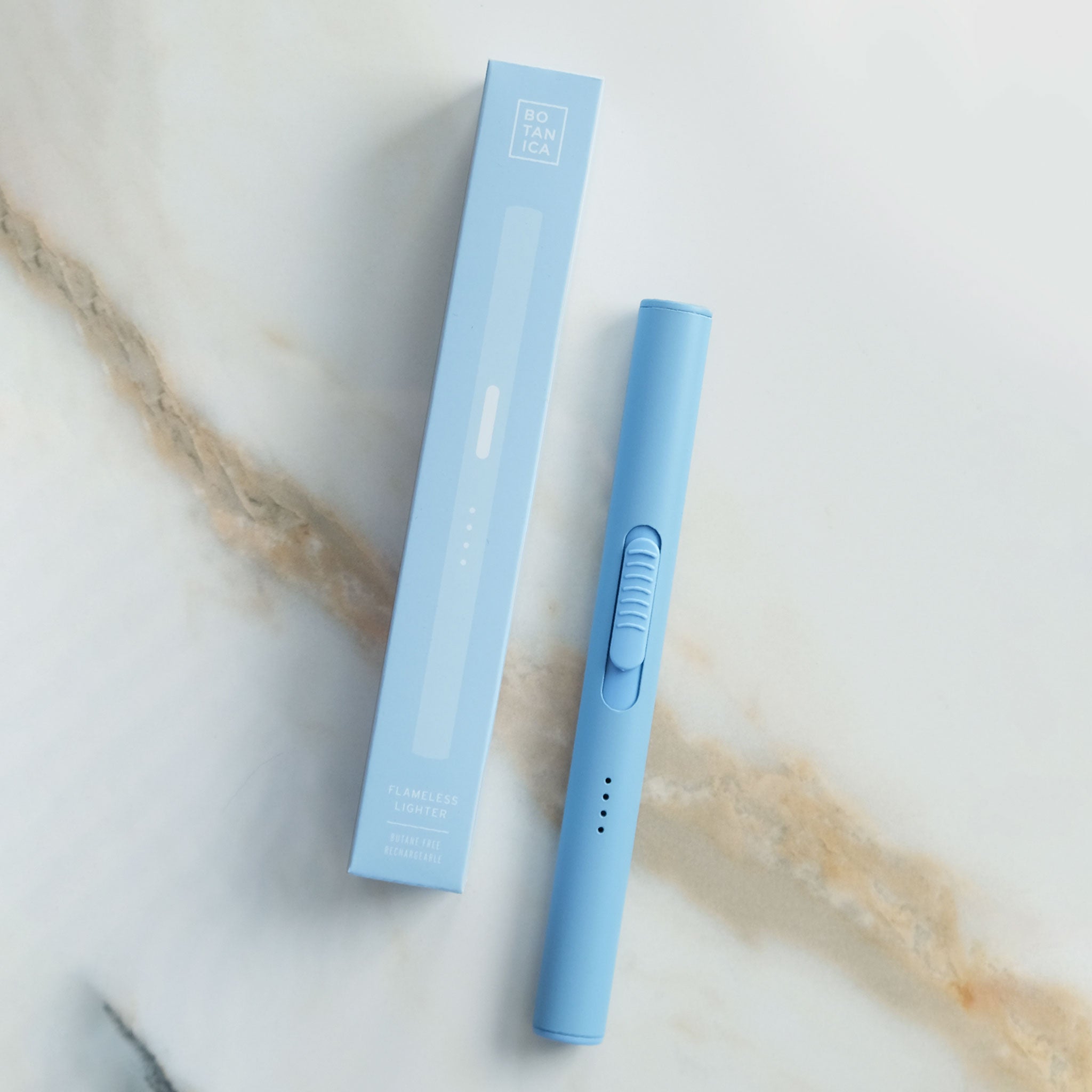 flameless lighter in bright blue shown against a neutral marble background