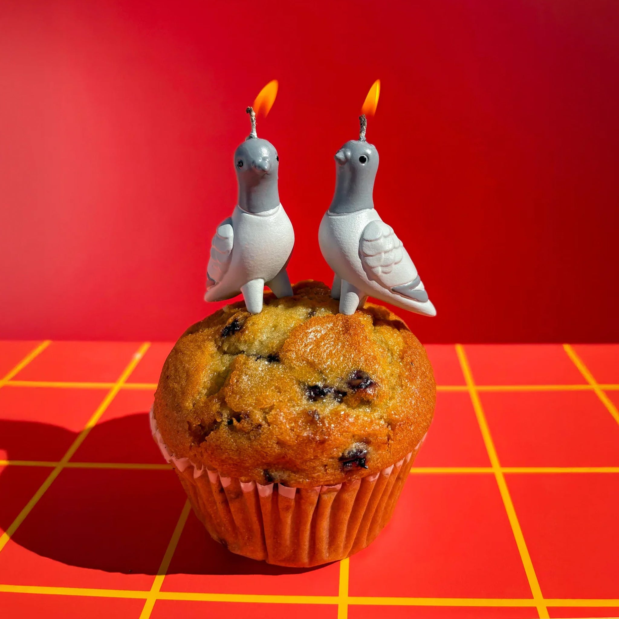 A set of four pigeon shaped candles. 