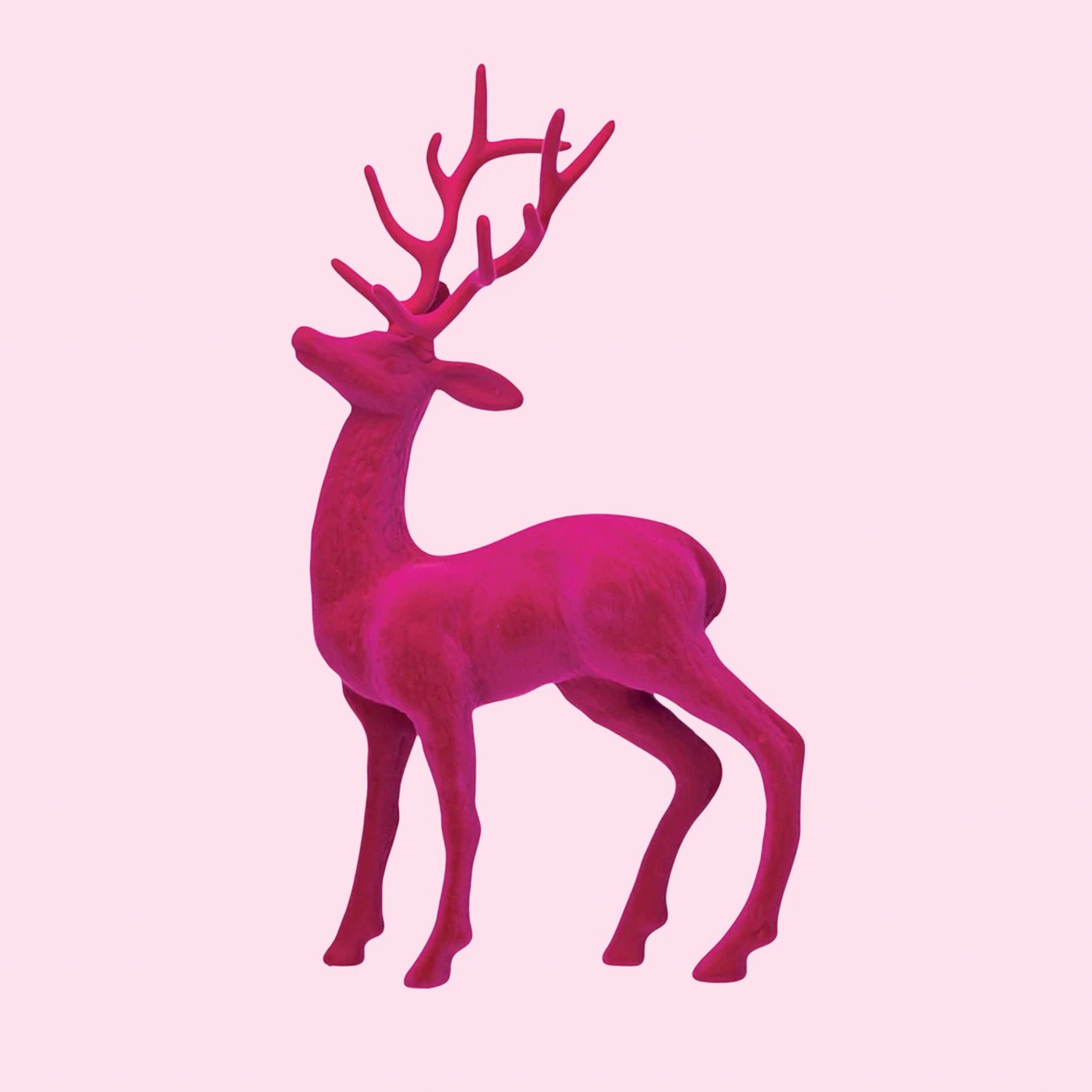 Bright pink flocked deer figurine. 