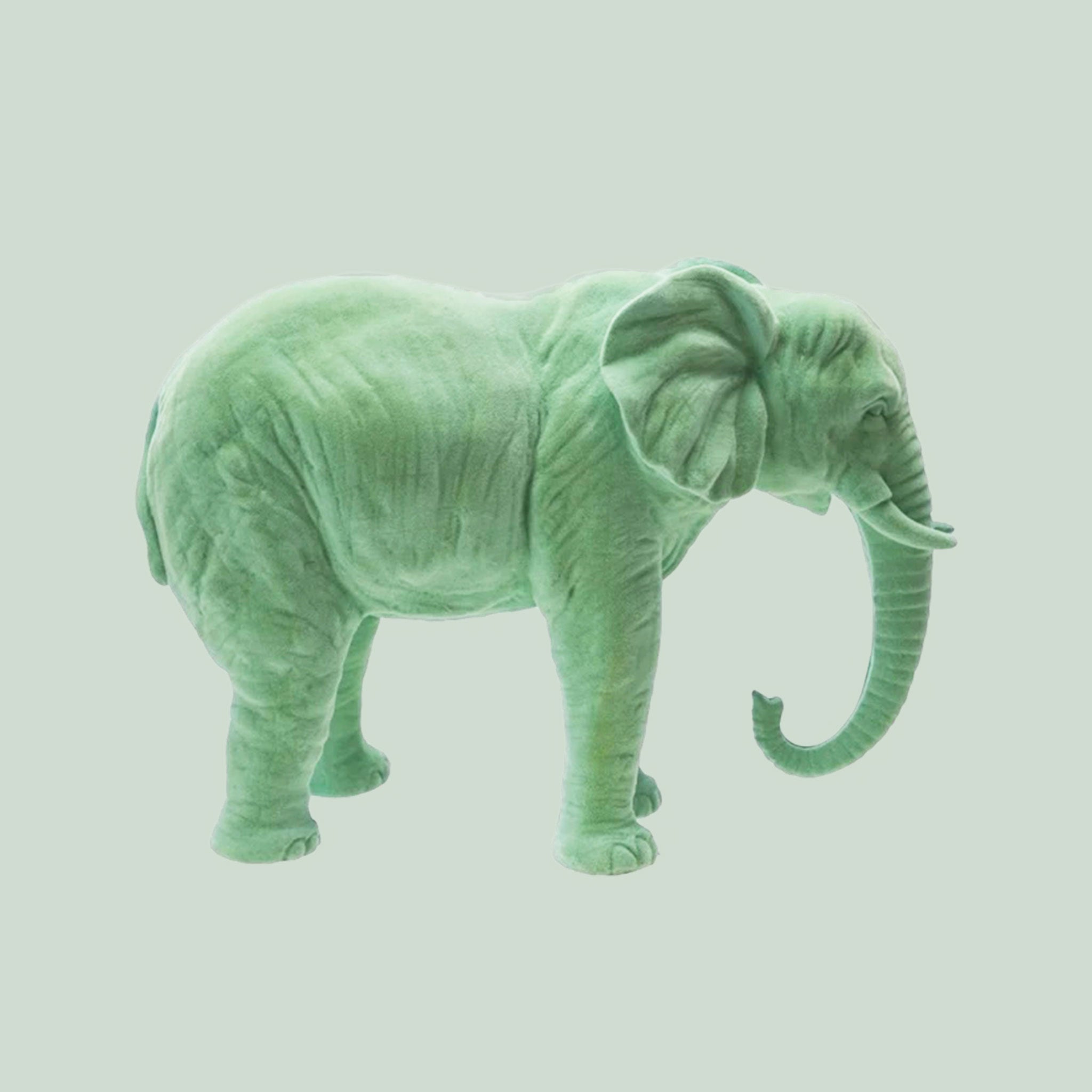 Mint colored flocked elephant statue. 