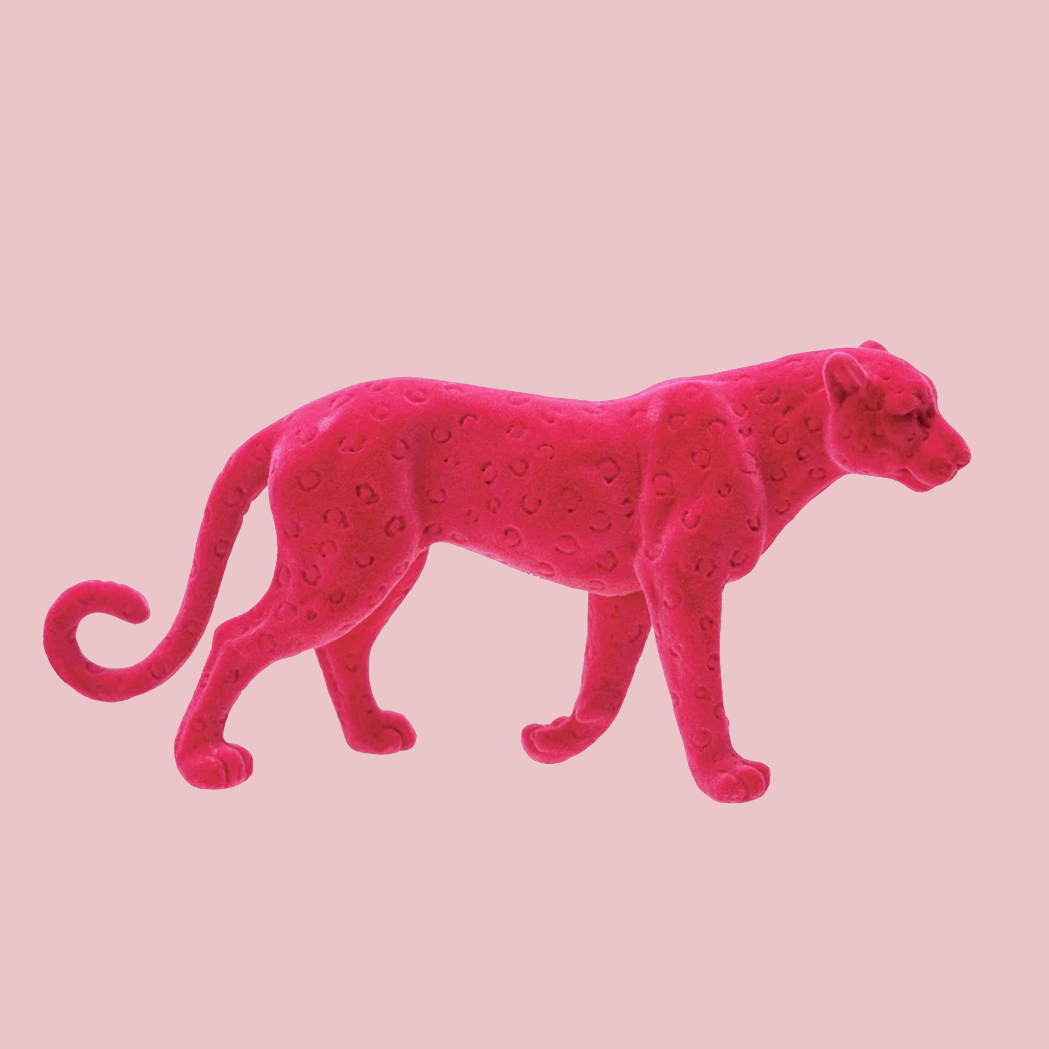 A pink flocked leopard shaped figurine. 