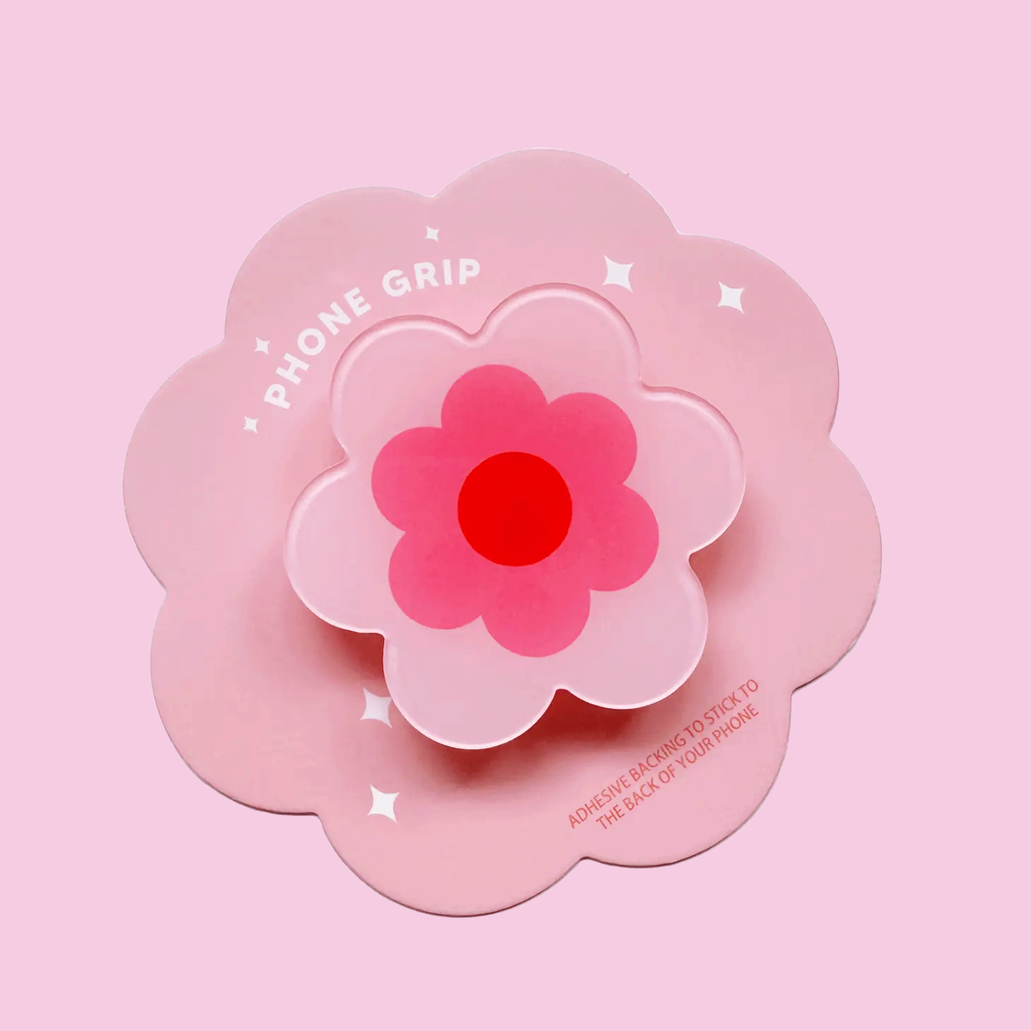 On a pink background is a pink flower shape phone grip.On a white background is a pink flower shape phone grip.