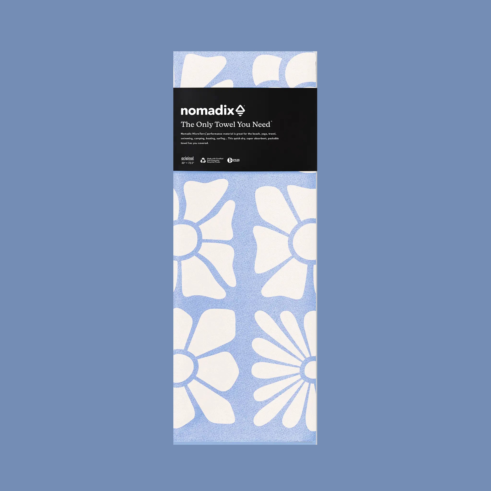 Packaged towel with white floral pattern on a blue background, featuring the brand 'nomadix'.