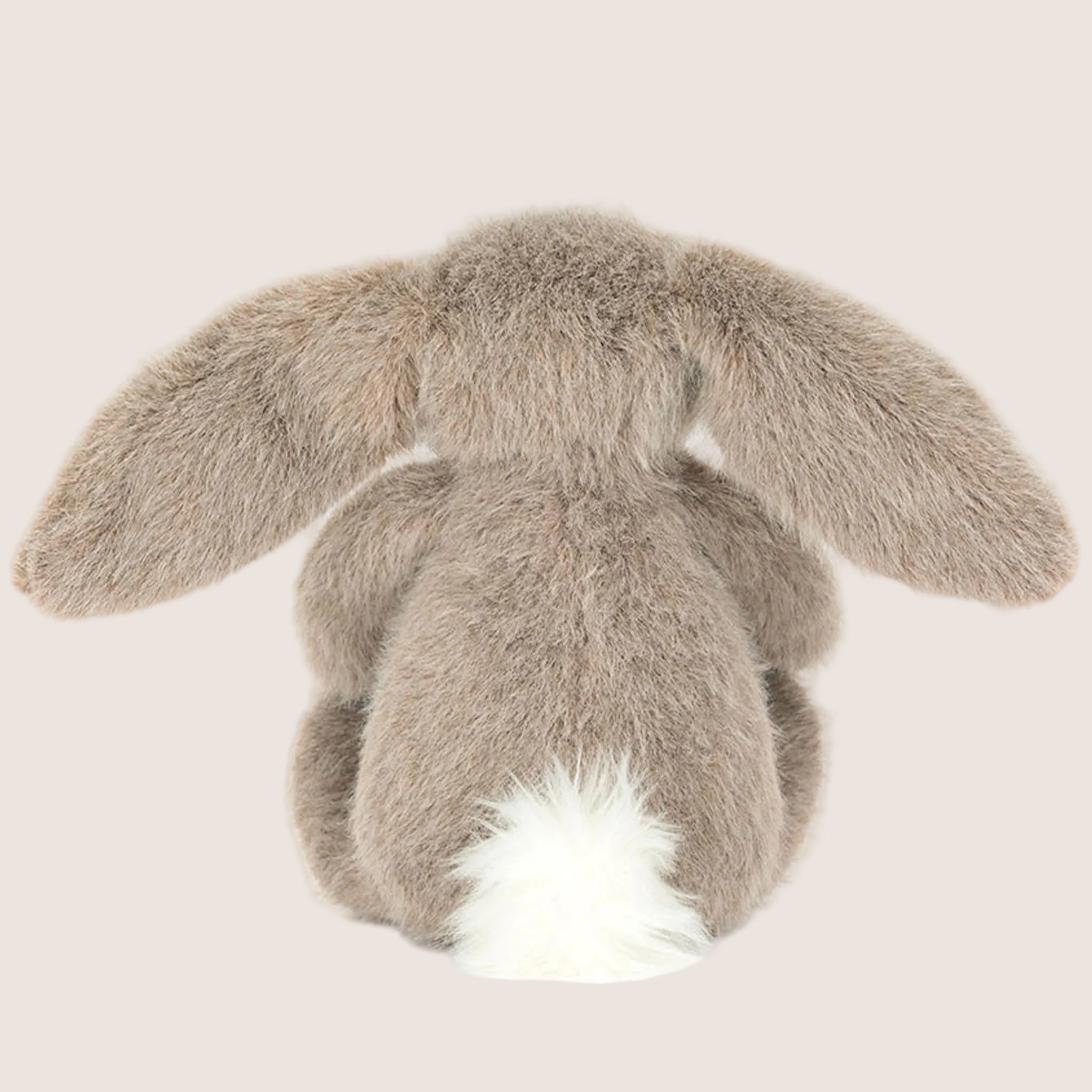 A brown bunny shaped stuffed animal.
