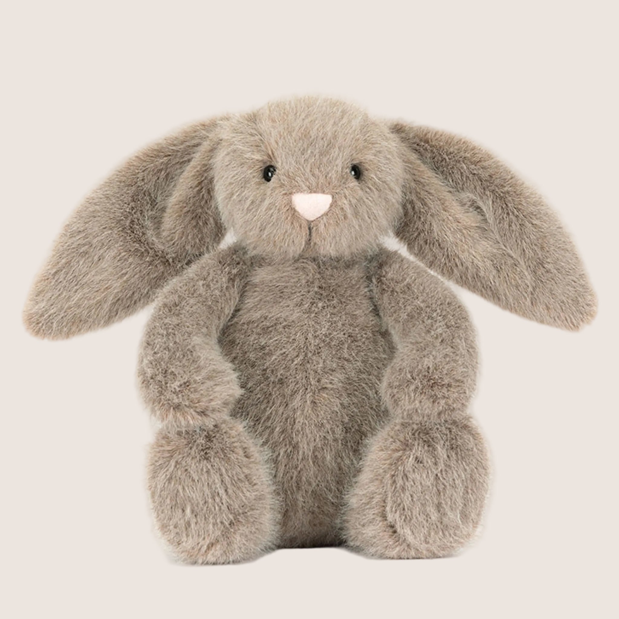 A brown bunny shaped stuffed animal.