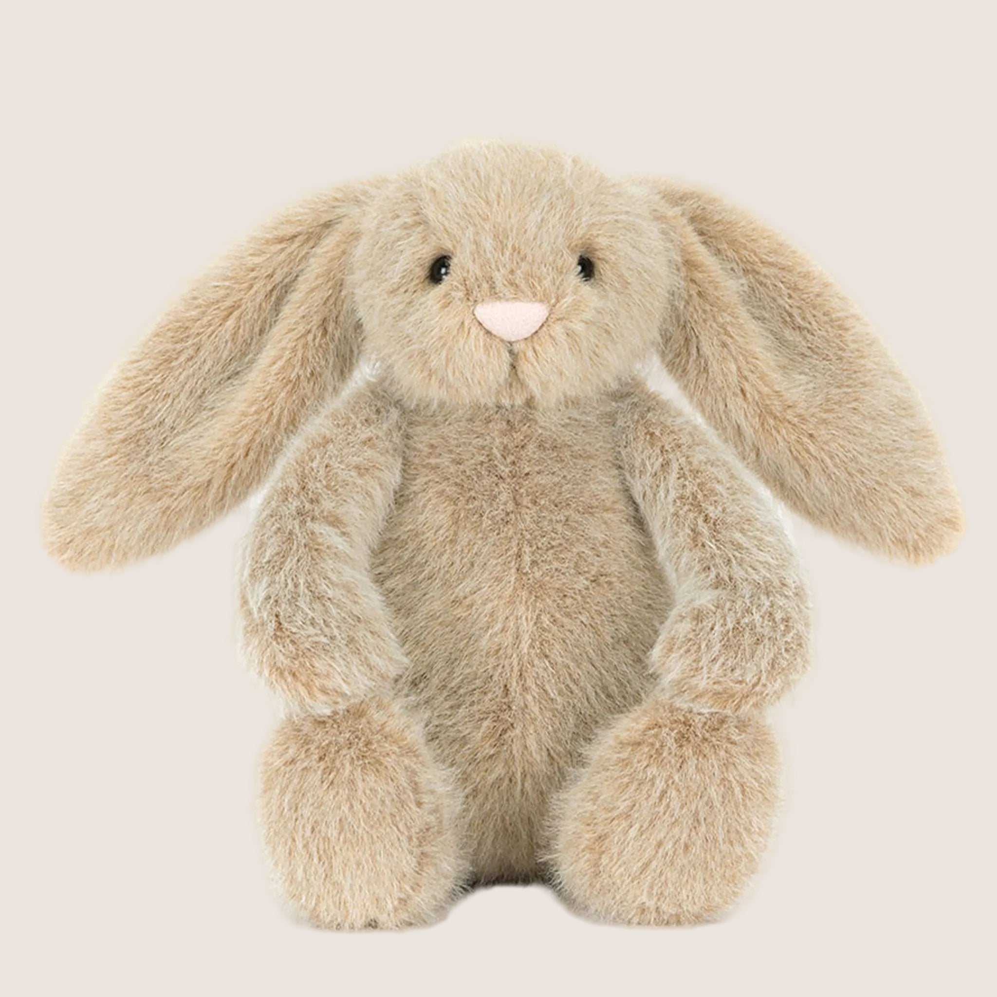 A tan fuzzy bunny shaped stuffed animal. 